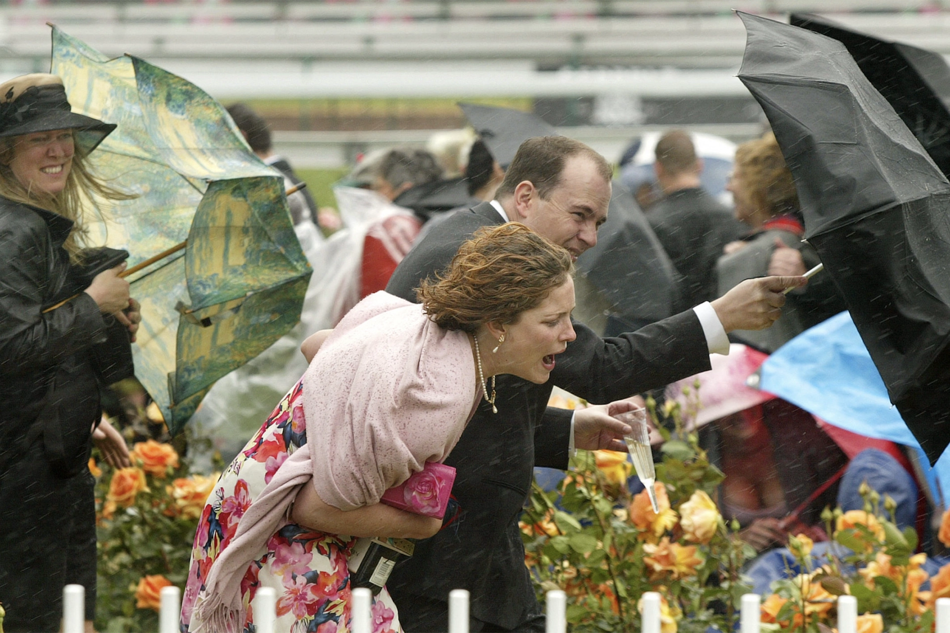 Racegoers in wind Melbourne Cup