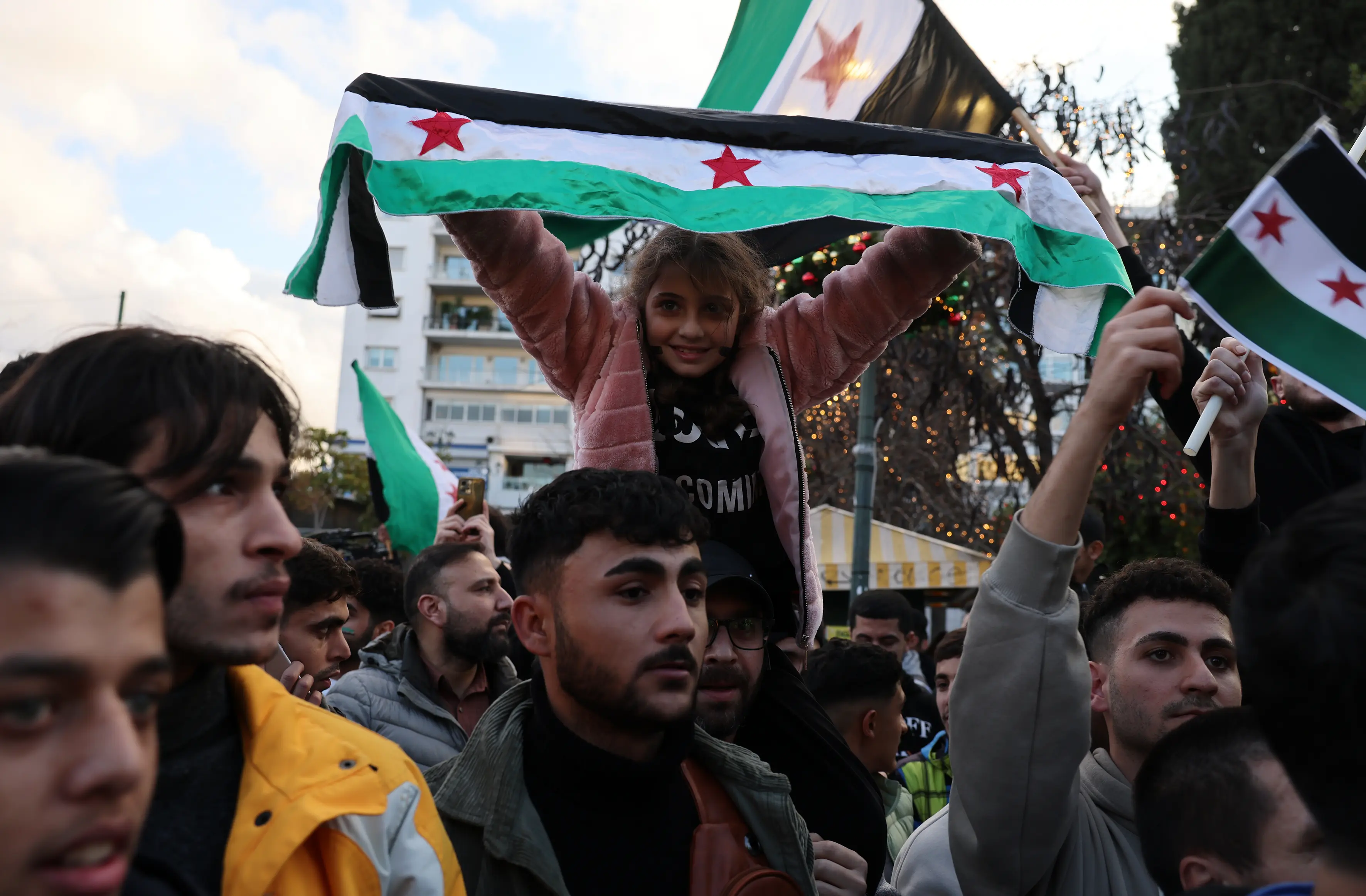 Syrians celebrating with flags in Athens