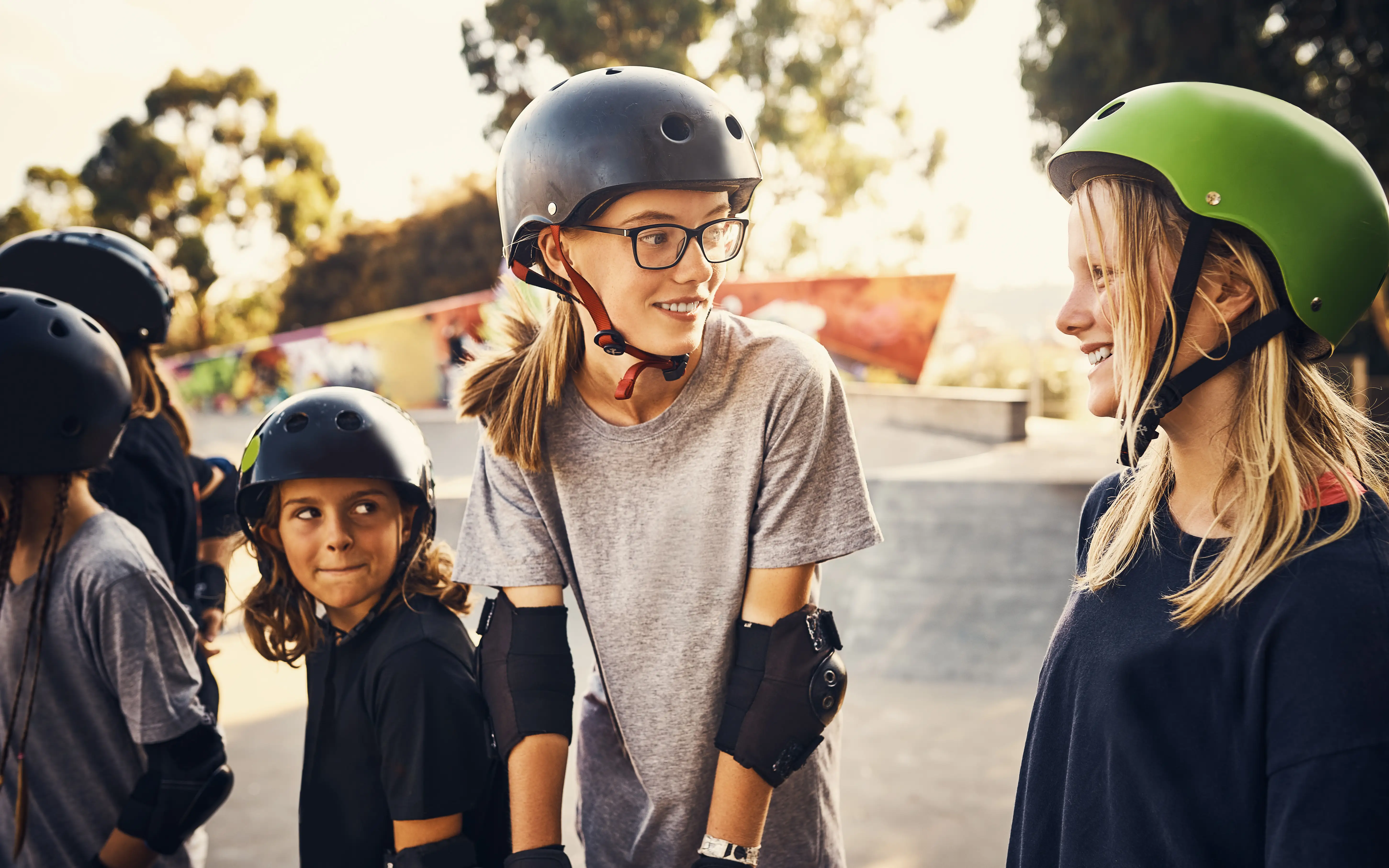 A group of young skaters girls chatting in a park