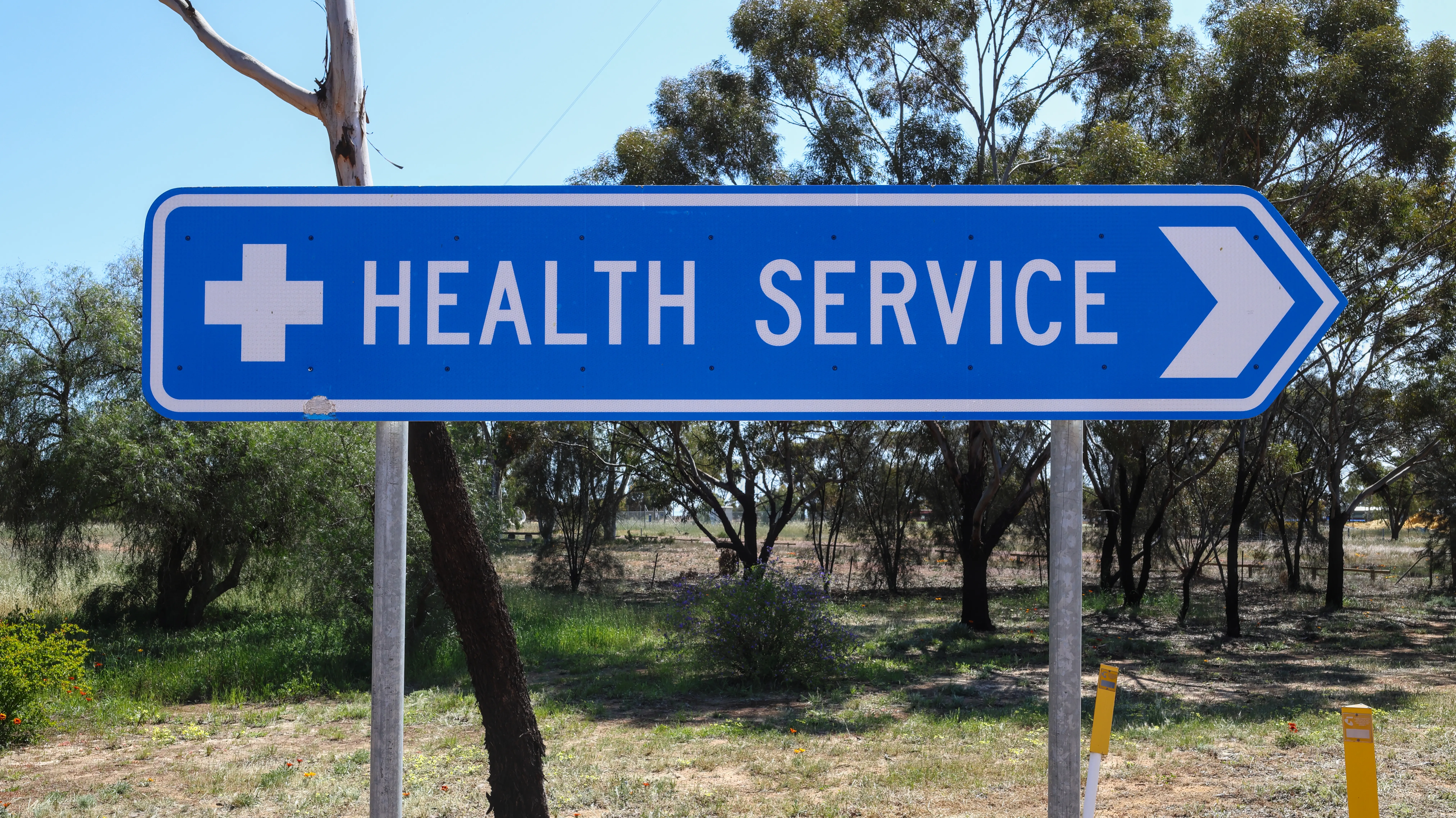 Blue street sign pointing to hospital service in regional country town