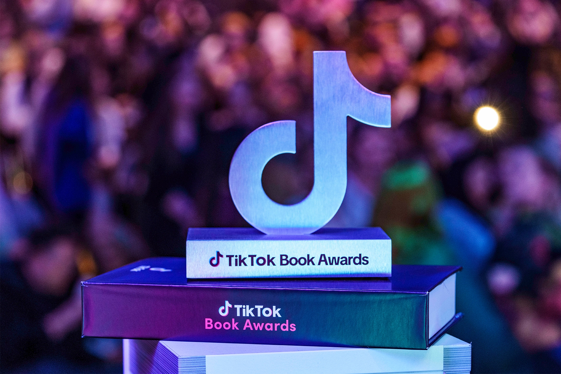 Musical note-shaped, silver award trophy with inscription reading: TikTok Book Awards