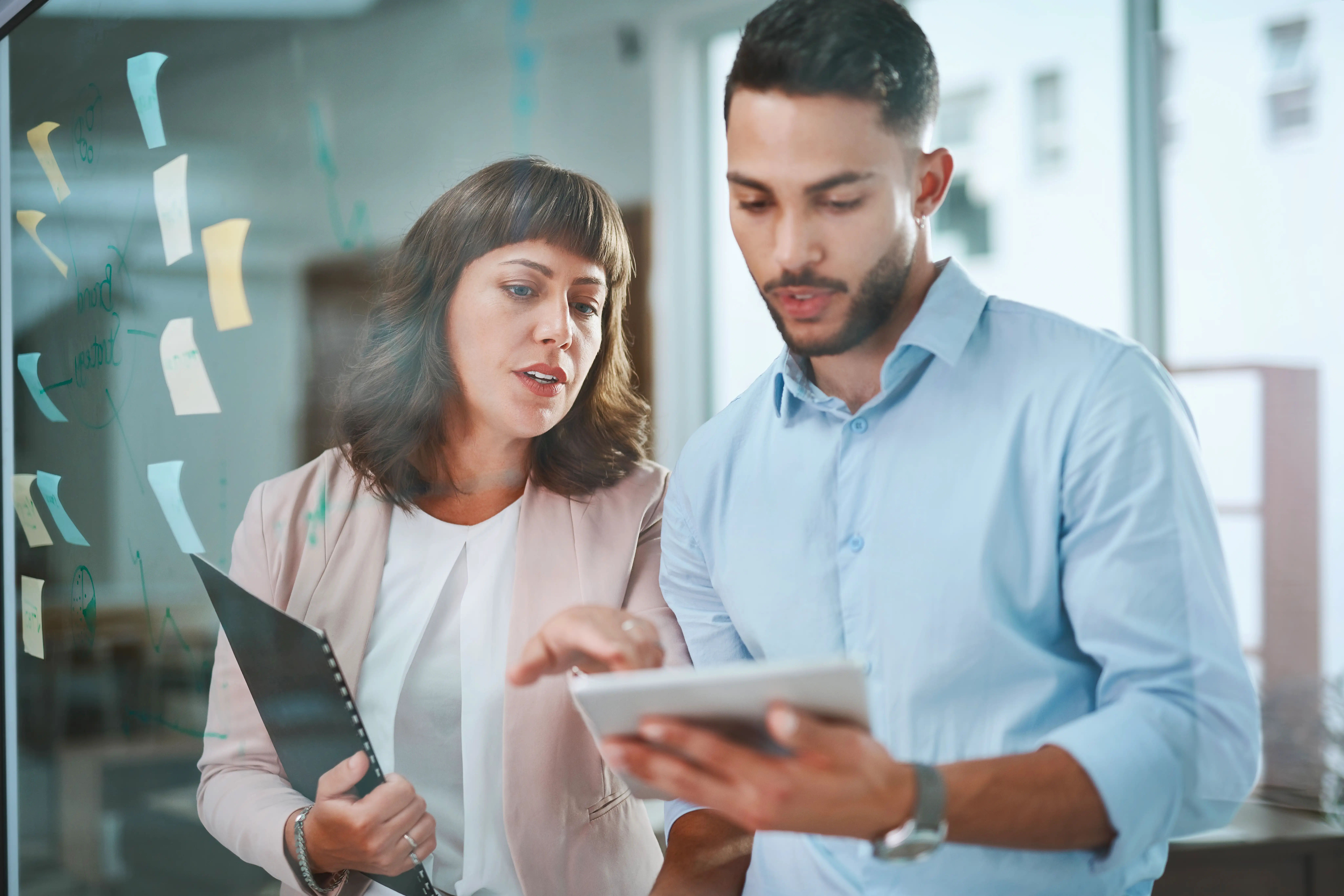 A young businessman and his boss using a digital tablet during a brainstorming session