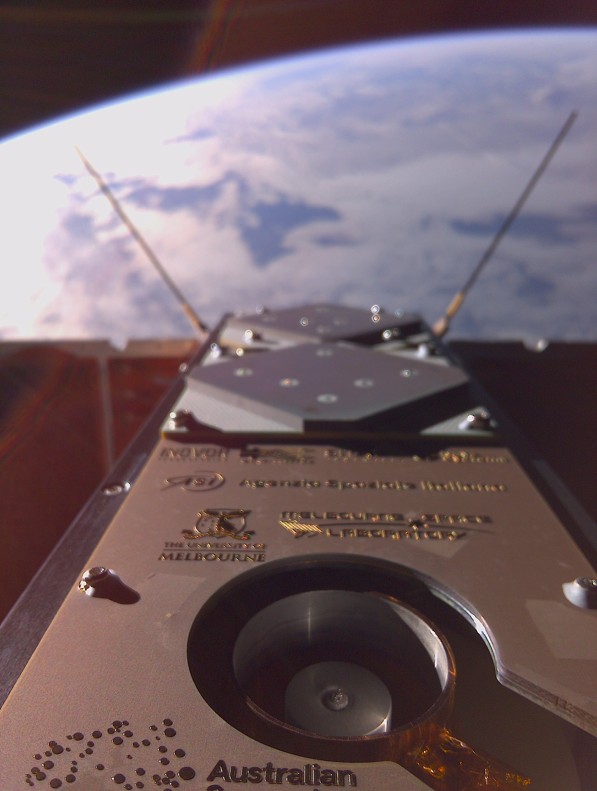 The underside of a small orbiting satellite looking towards Earth