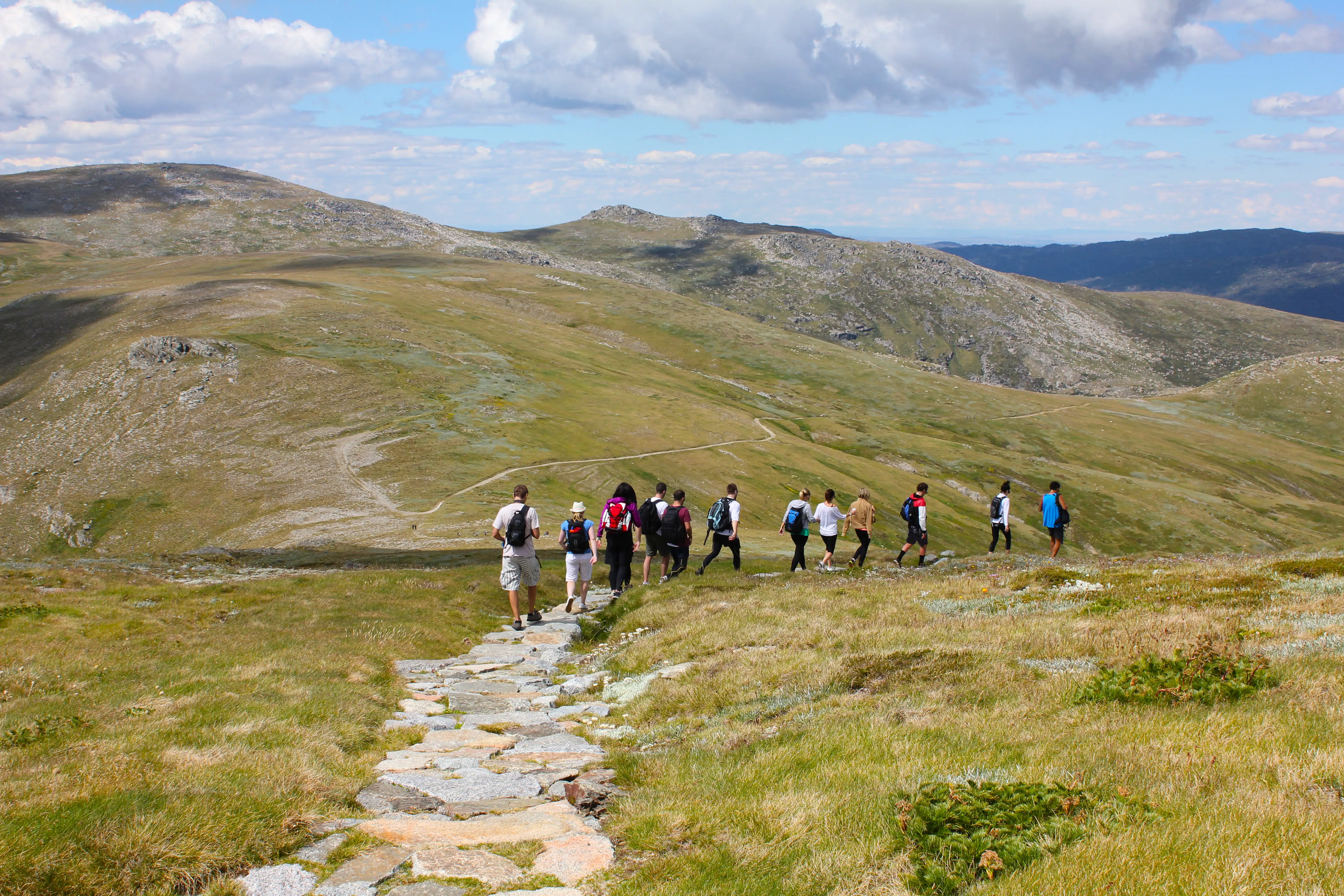 A group of walkers on a trail in Mt Kosciusko National Park, Australia.