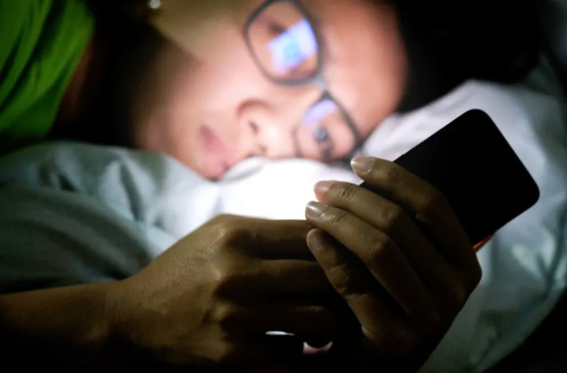 Teen on screen at nigh