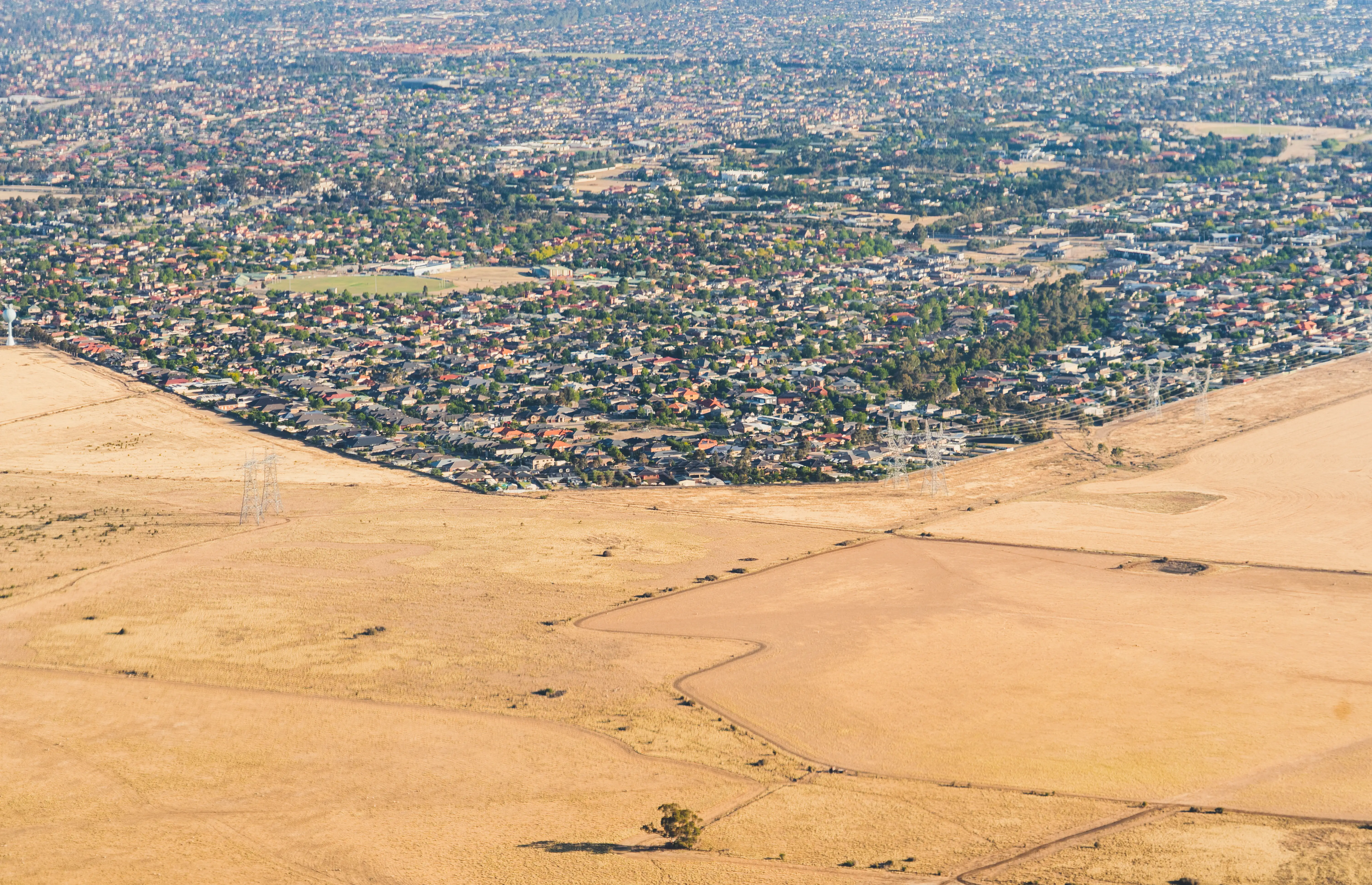 Drought affects Melbourne's outskirts as bushfire smog covers the sky.
