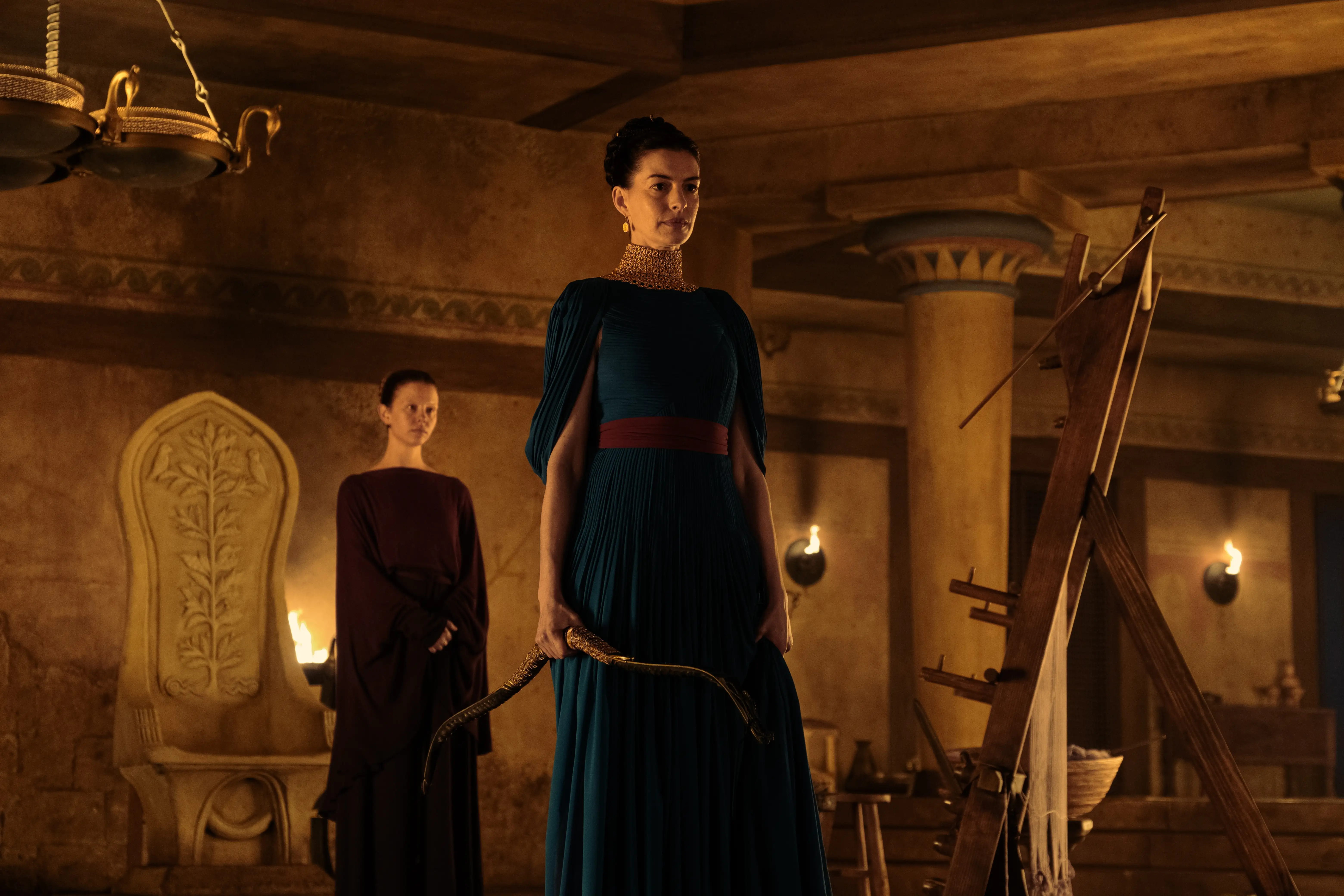 Anne Hathaway as Penelope in a low-lit room