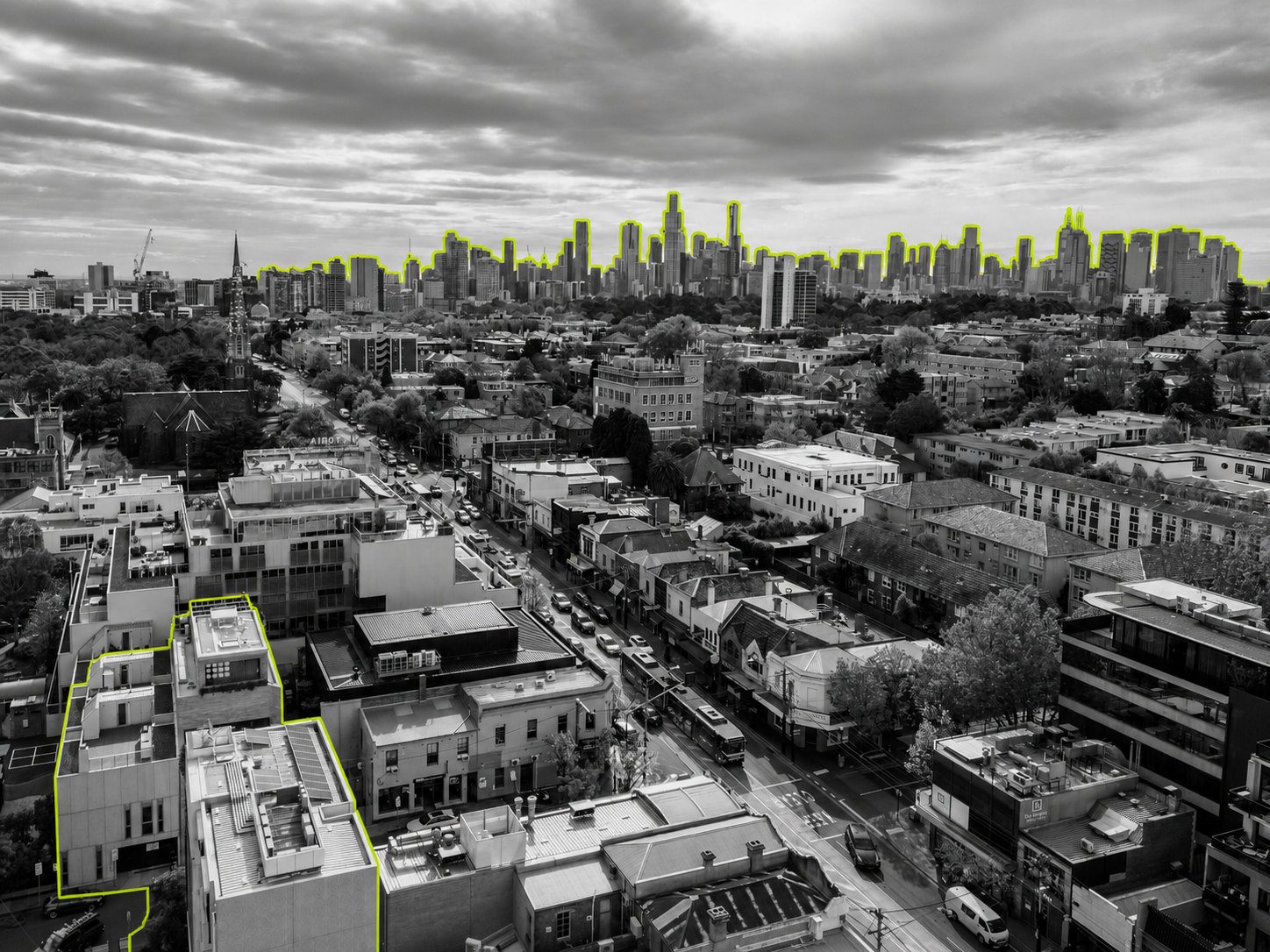 A black-and-white photo of Melbourne's skyline with elements picked out in lime green