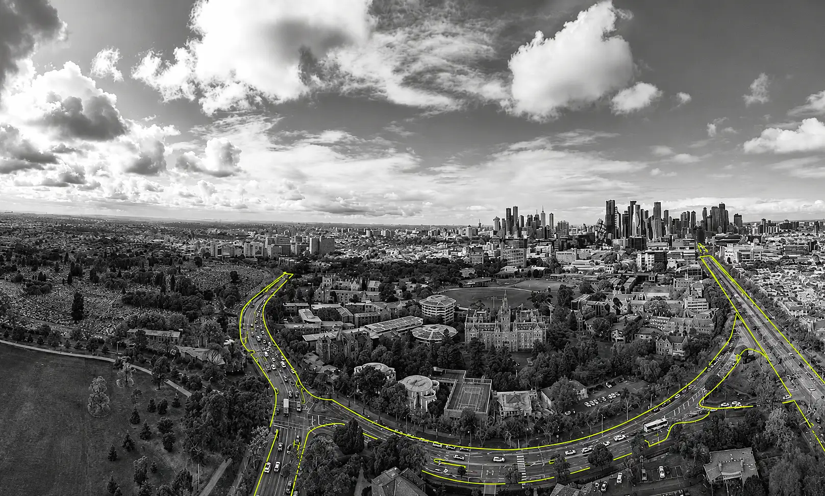 A black-and-white aerial photo of the University of Melbourne with elements picked out in lime green