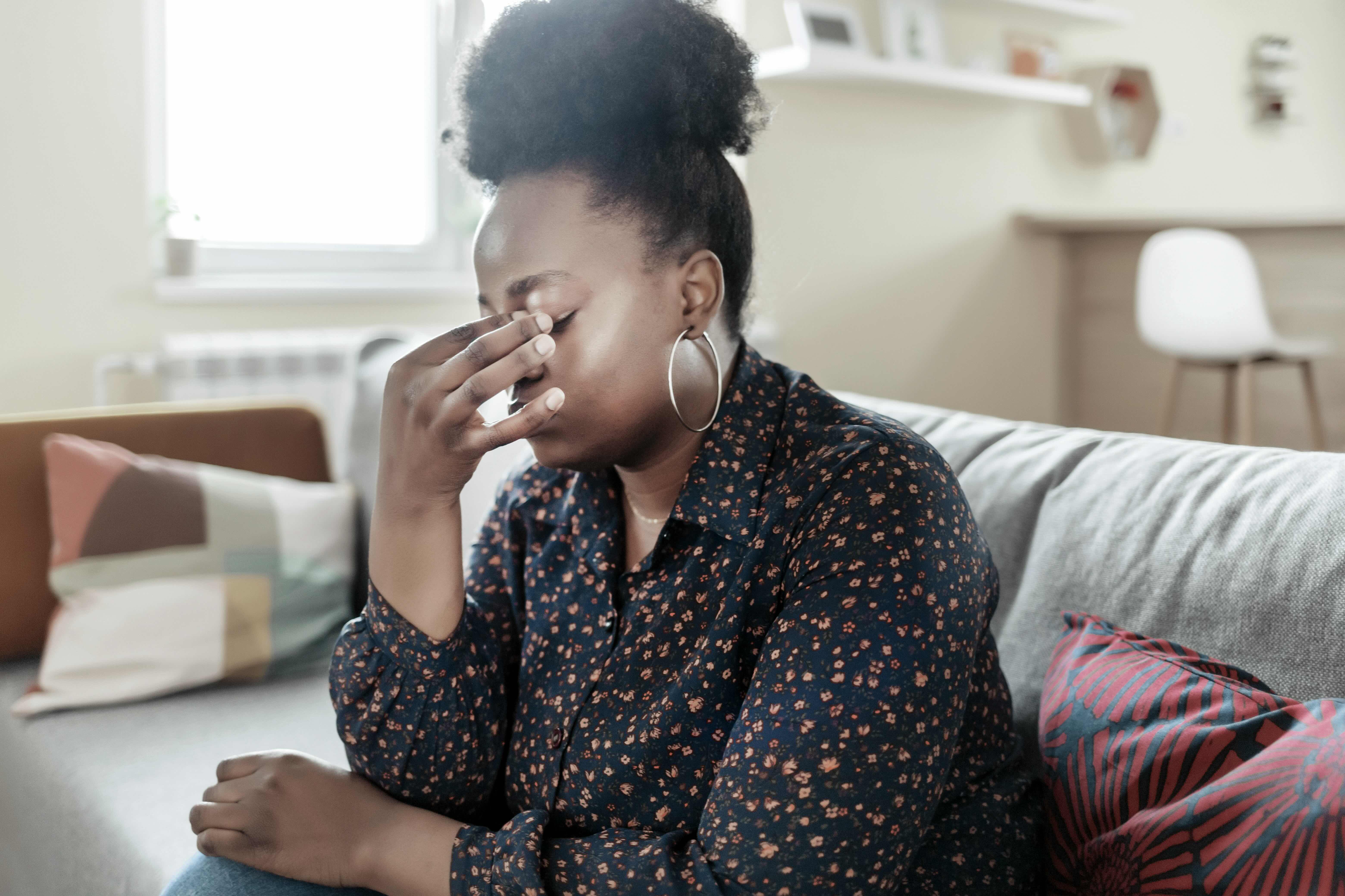 A stressed woman rubbing her forehead