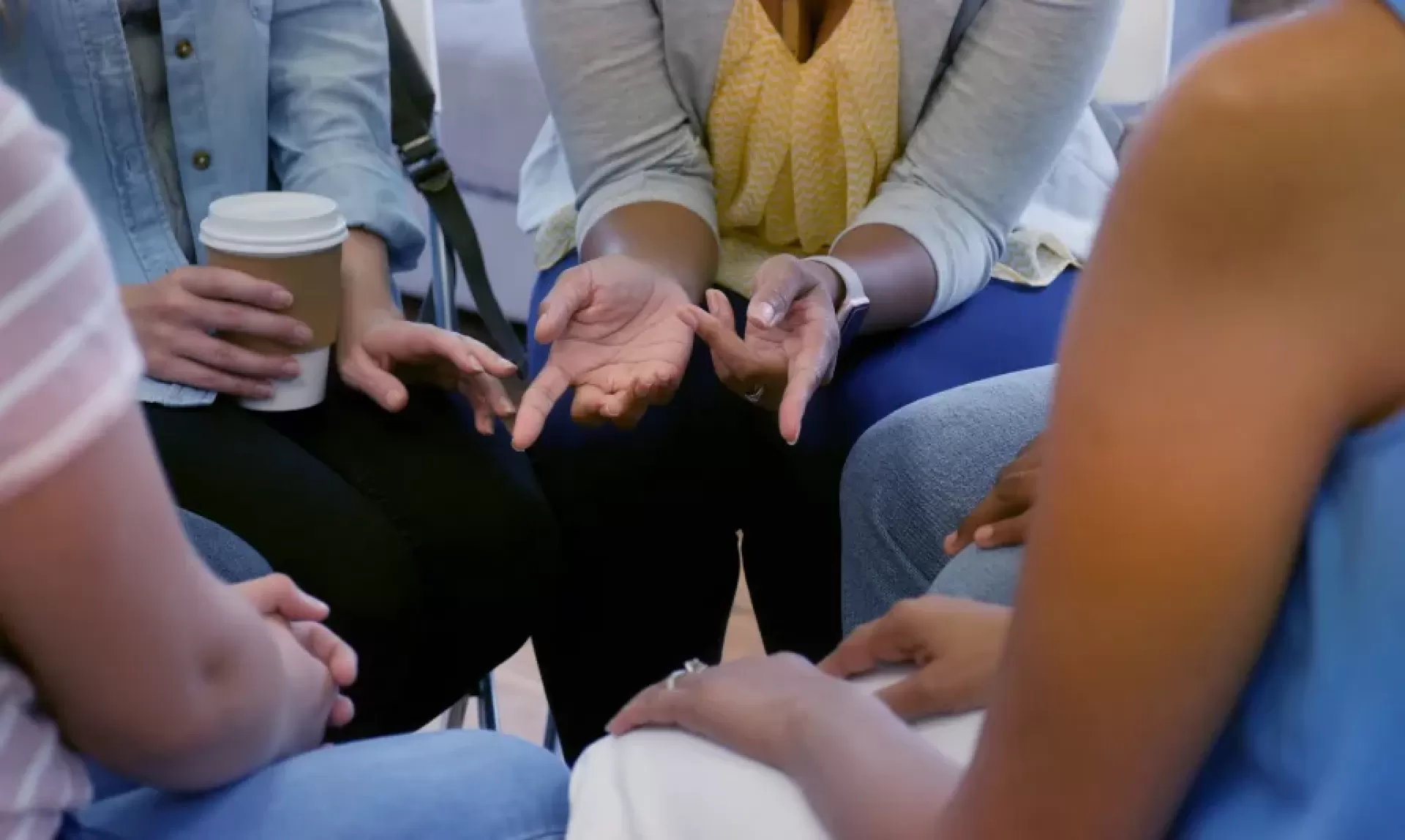 Group of people chatting, just hands in view