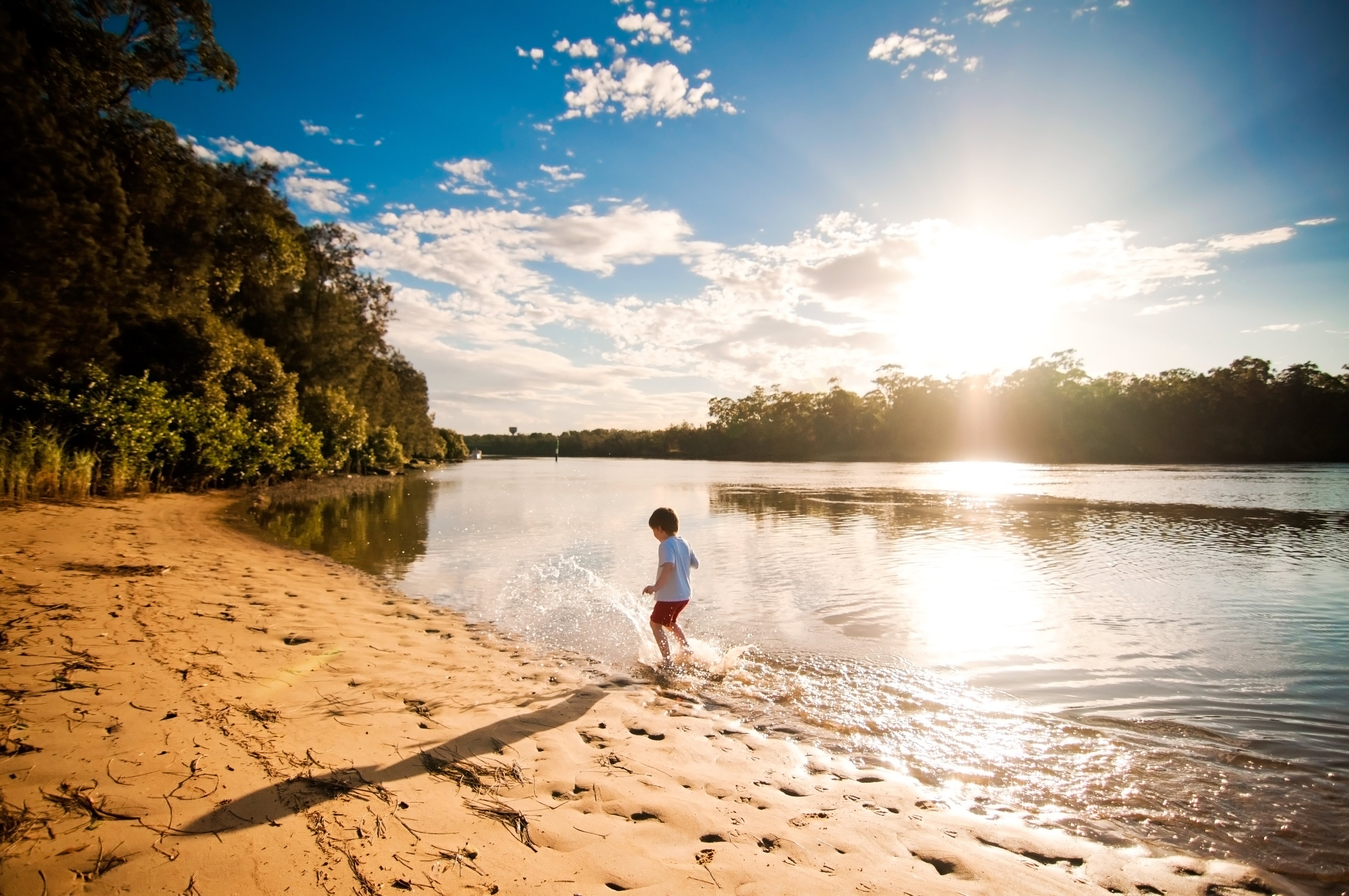 Child by the side of a lake