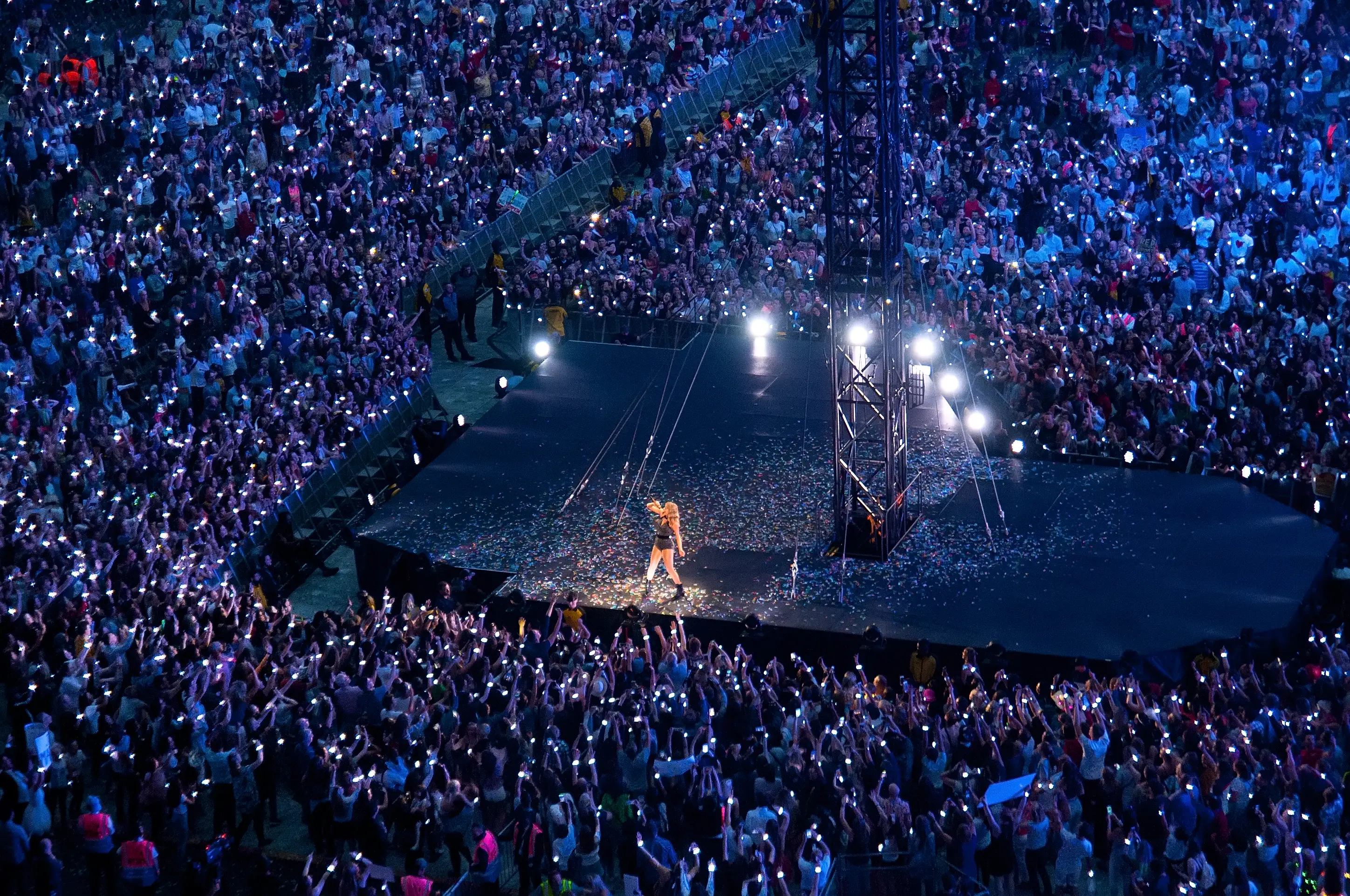 Taylor Swift performs at Wembley Stadium surrounded by mobile phone lights