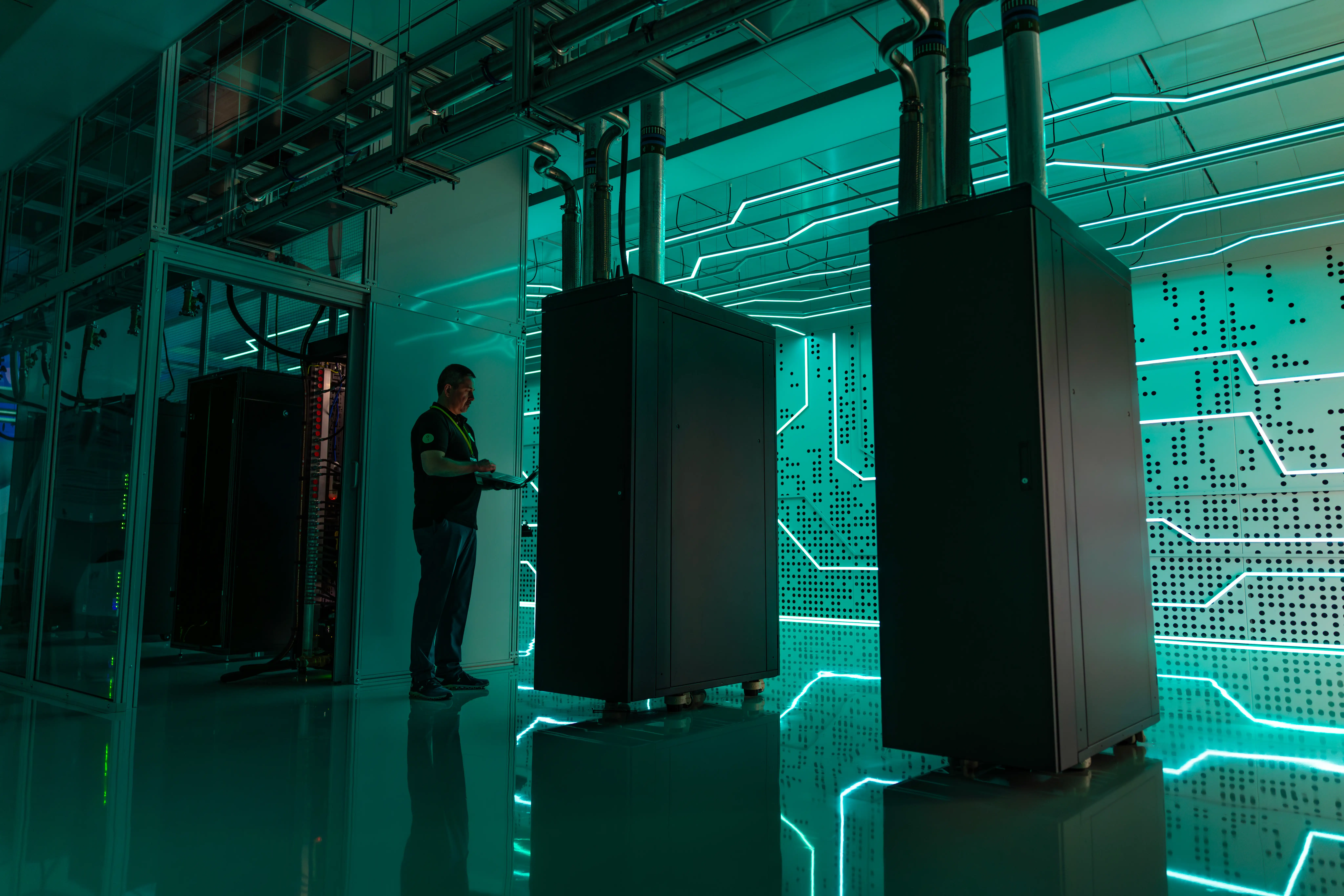 A technician checks liquid cooled servers in a data centre