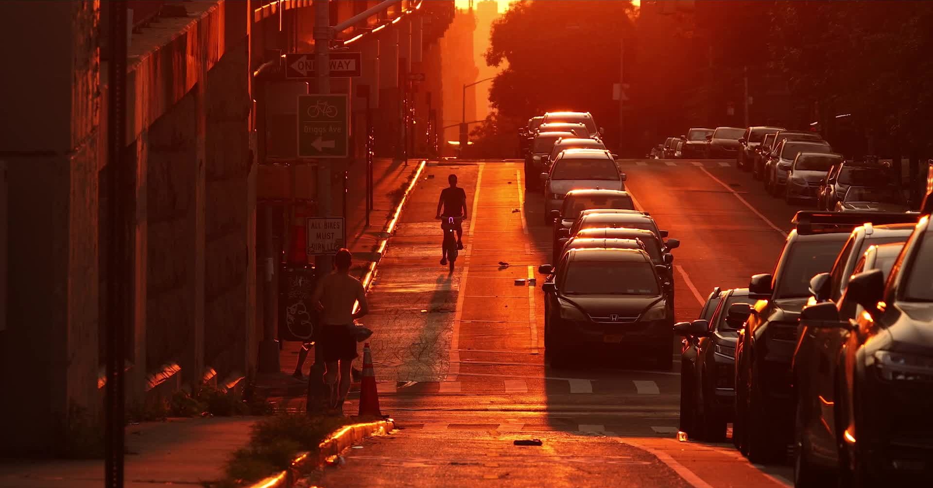 A busy city street glowing red in sunset heat