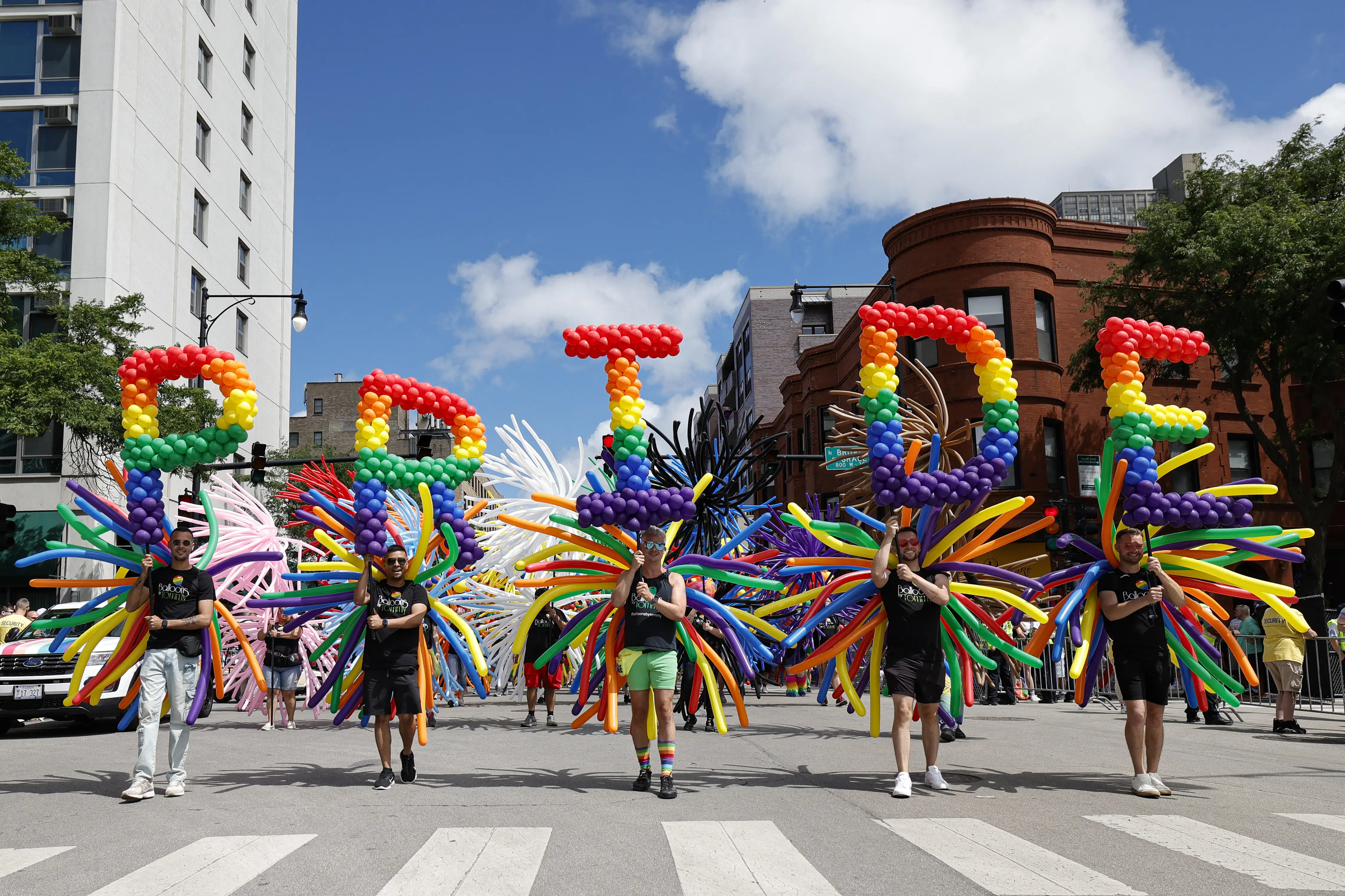 Participants carrying ballons spelling out 'Pride' on a Chicago street