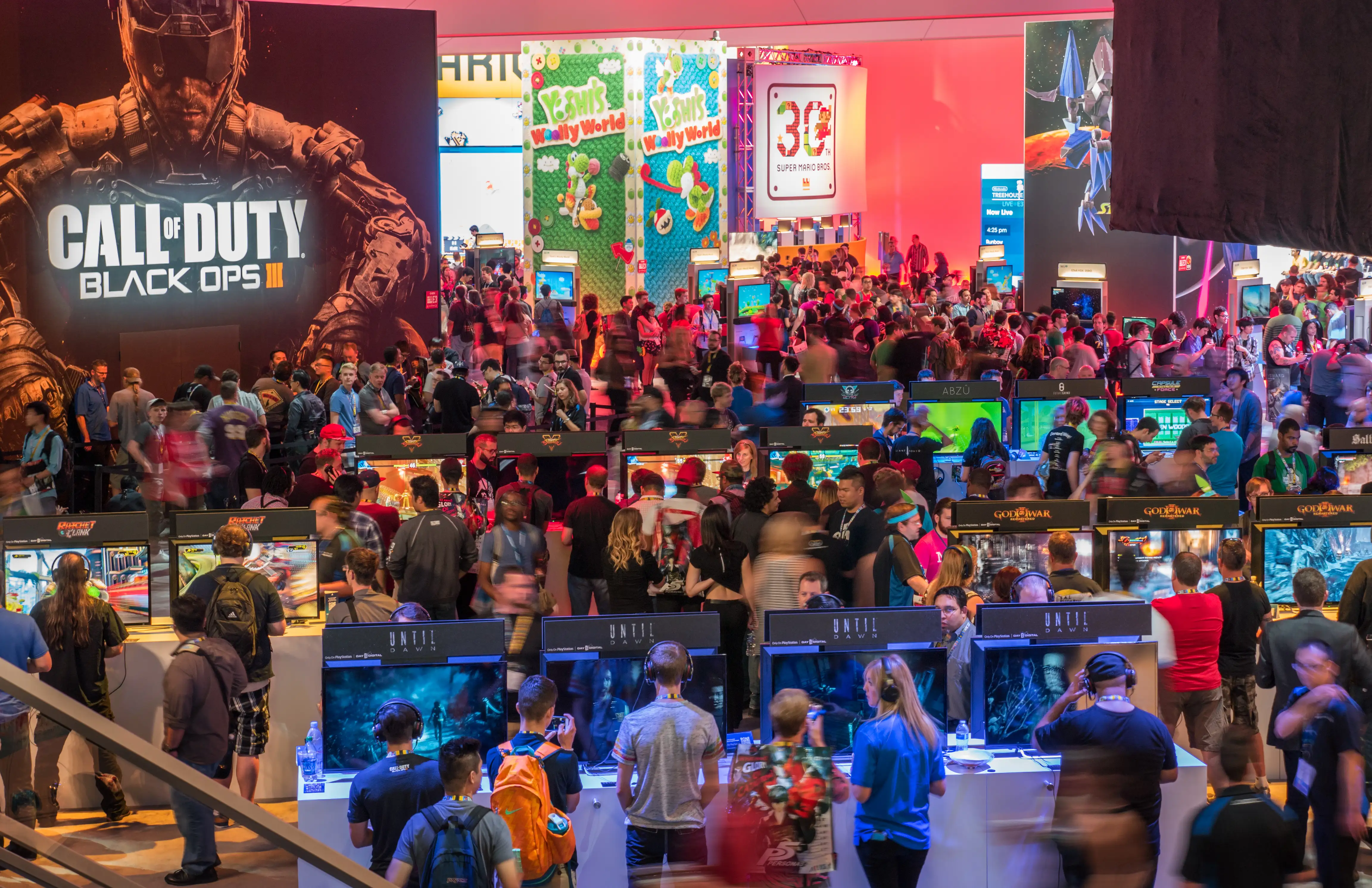 Gamers dress up in cosplay at a crowded gaming convention