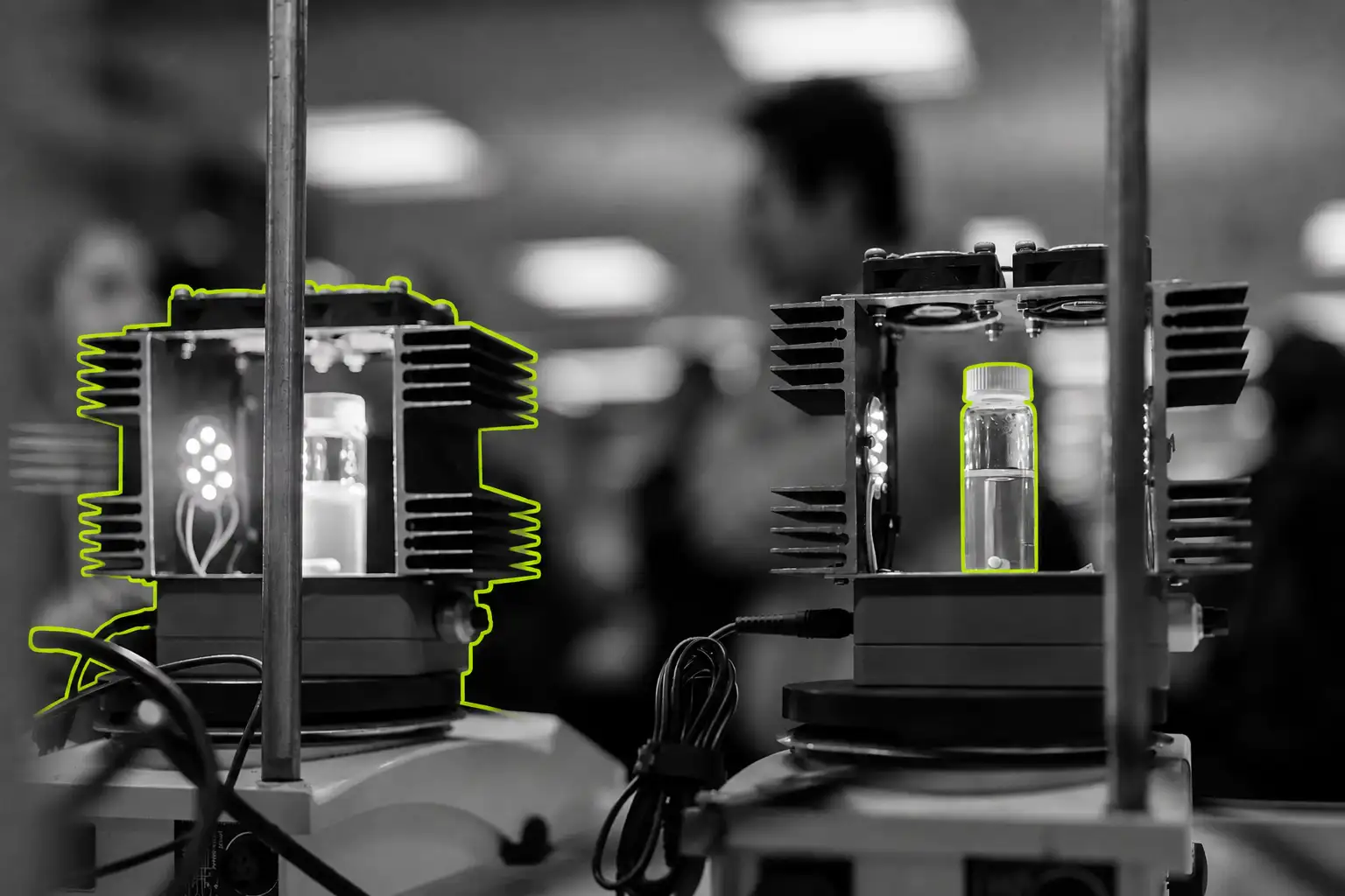 A black-and-white photo of an engineering lab at the University of Melbourne with elements picked out in lime green
