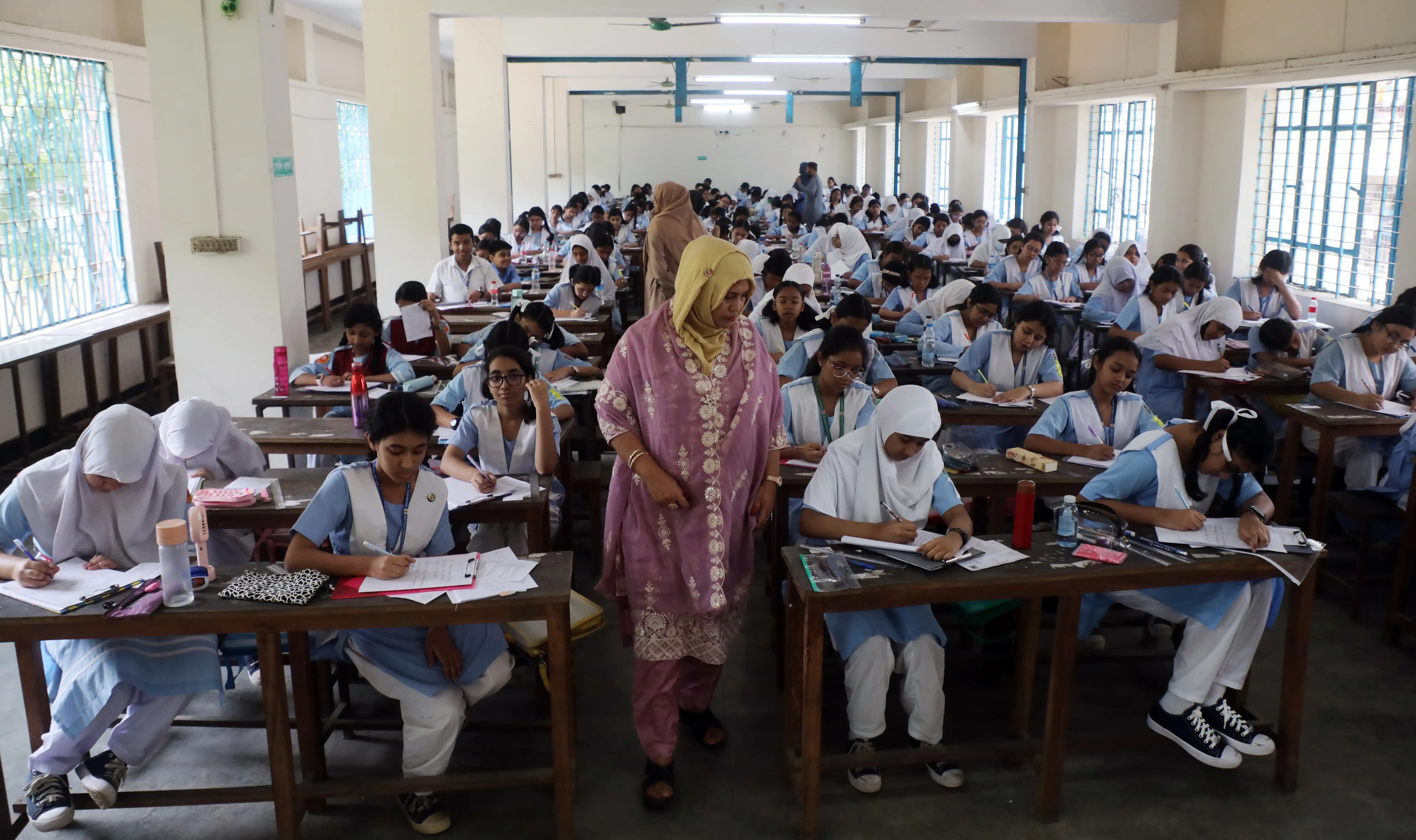 A full classroom of students sitting at their desks in a Bangladeshi school