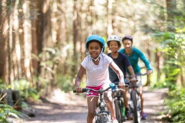 Young Kids Biking in Forest