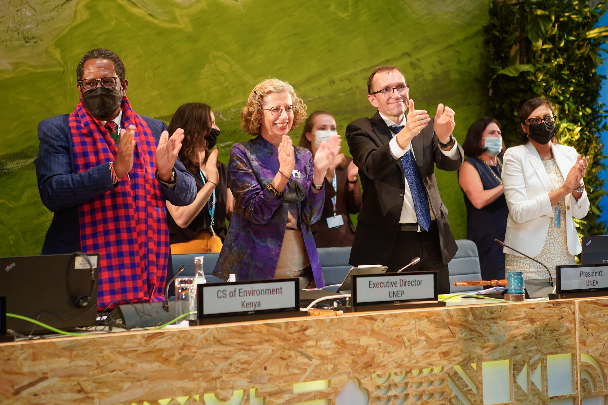 Delegates react after the United Nations agreed to start negotiating a world-first global treaty on plastic pollution