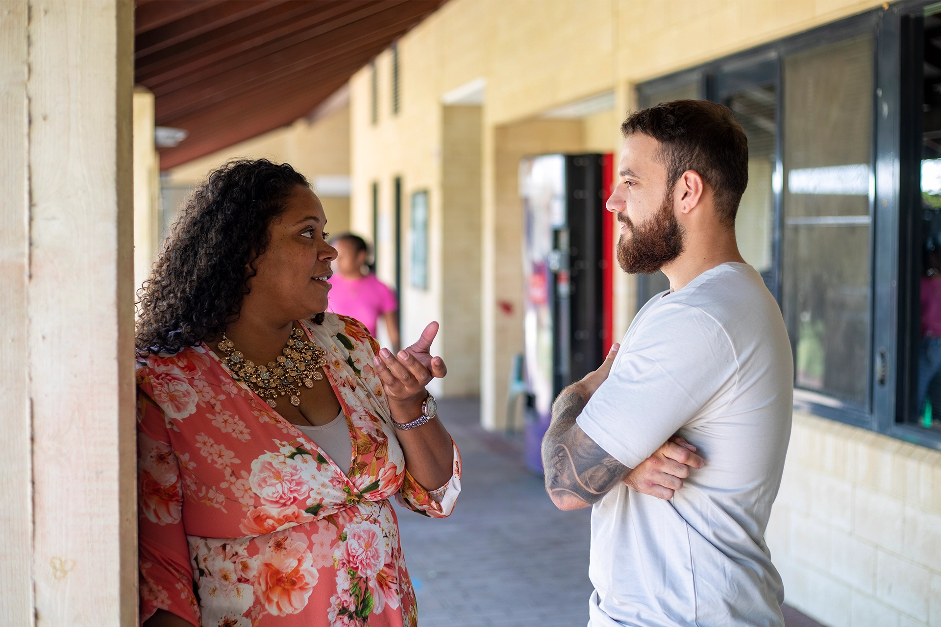 A female and male student talking outside at a regional university campus