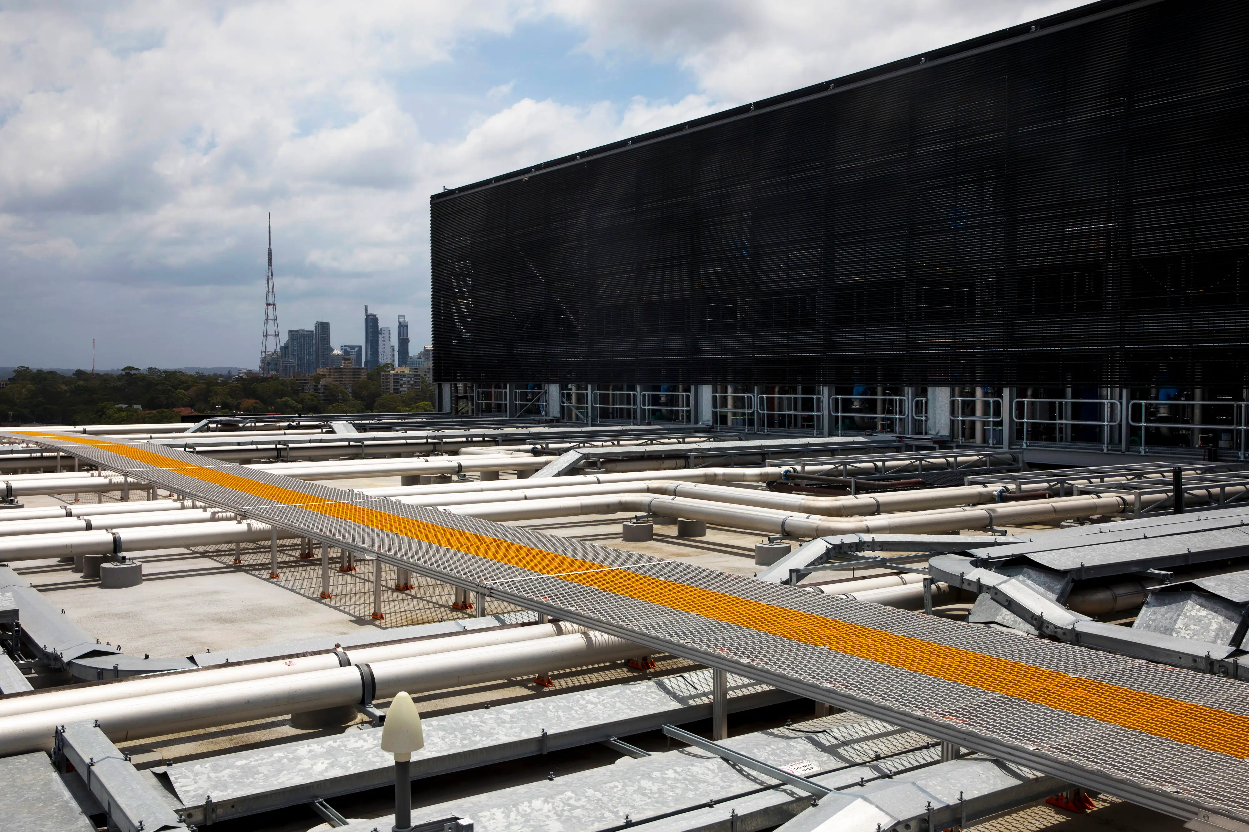 Pipes carry cold water near cooling towers at a data center in Sydney, Australia