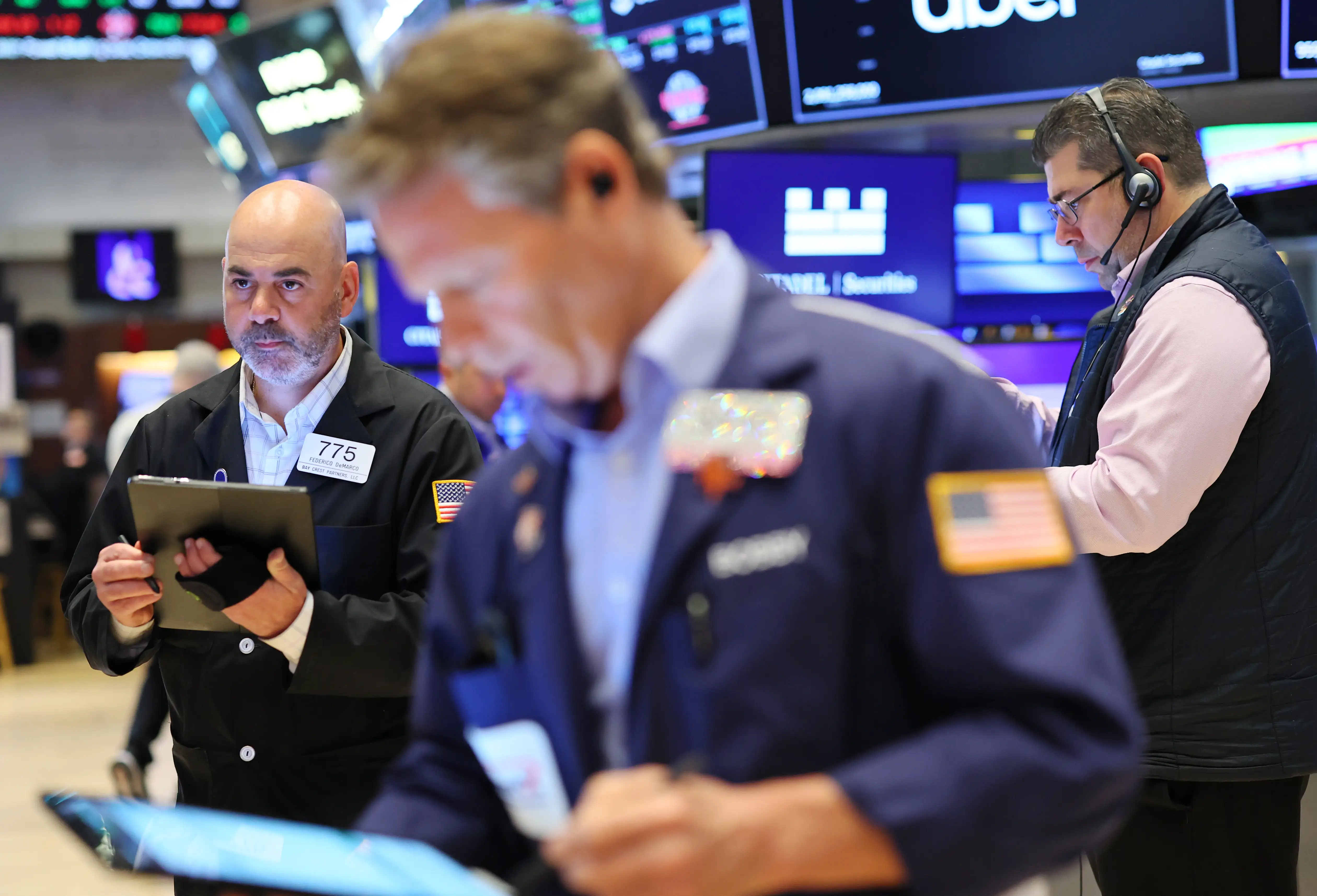 Traders work on the floor of the New York Stock Exchange during morning trading