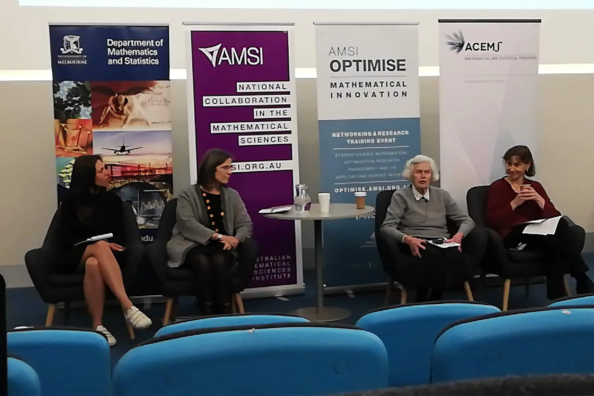 Four women sitting at a panel discussion