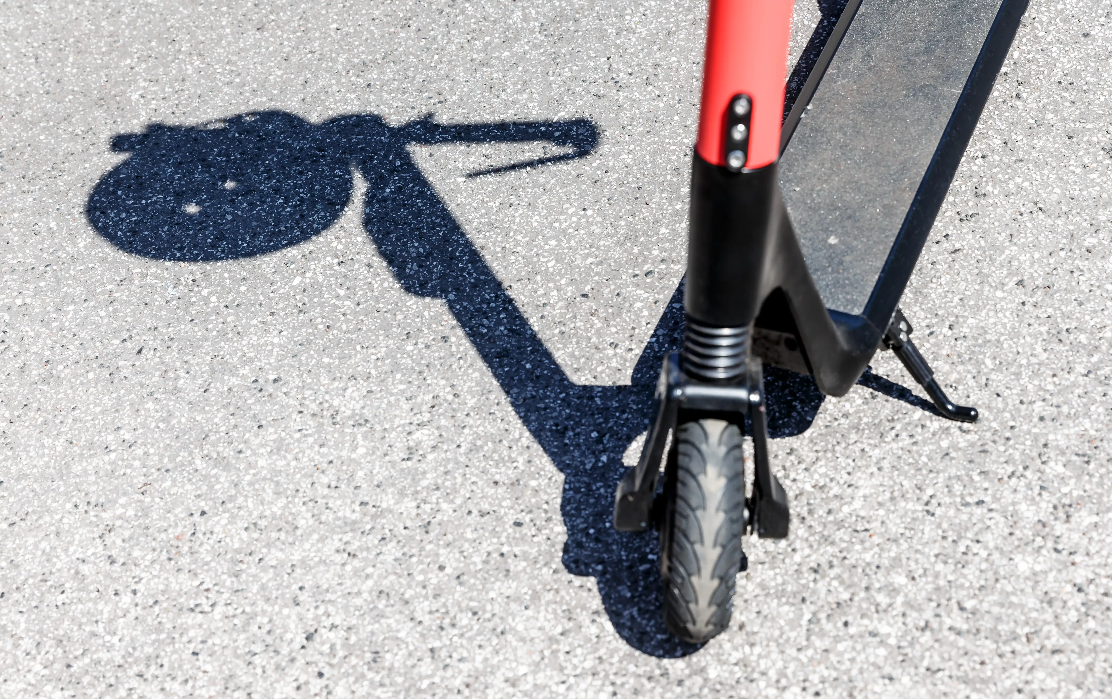 The shadow of a on the handle of an electric scooter 