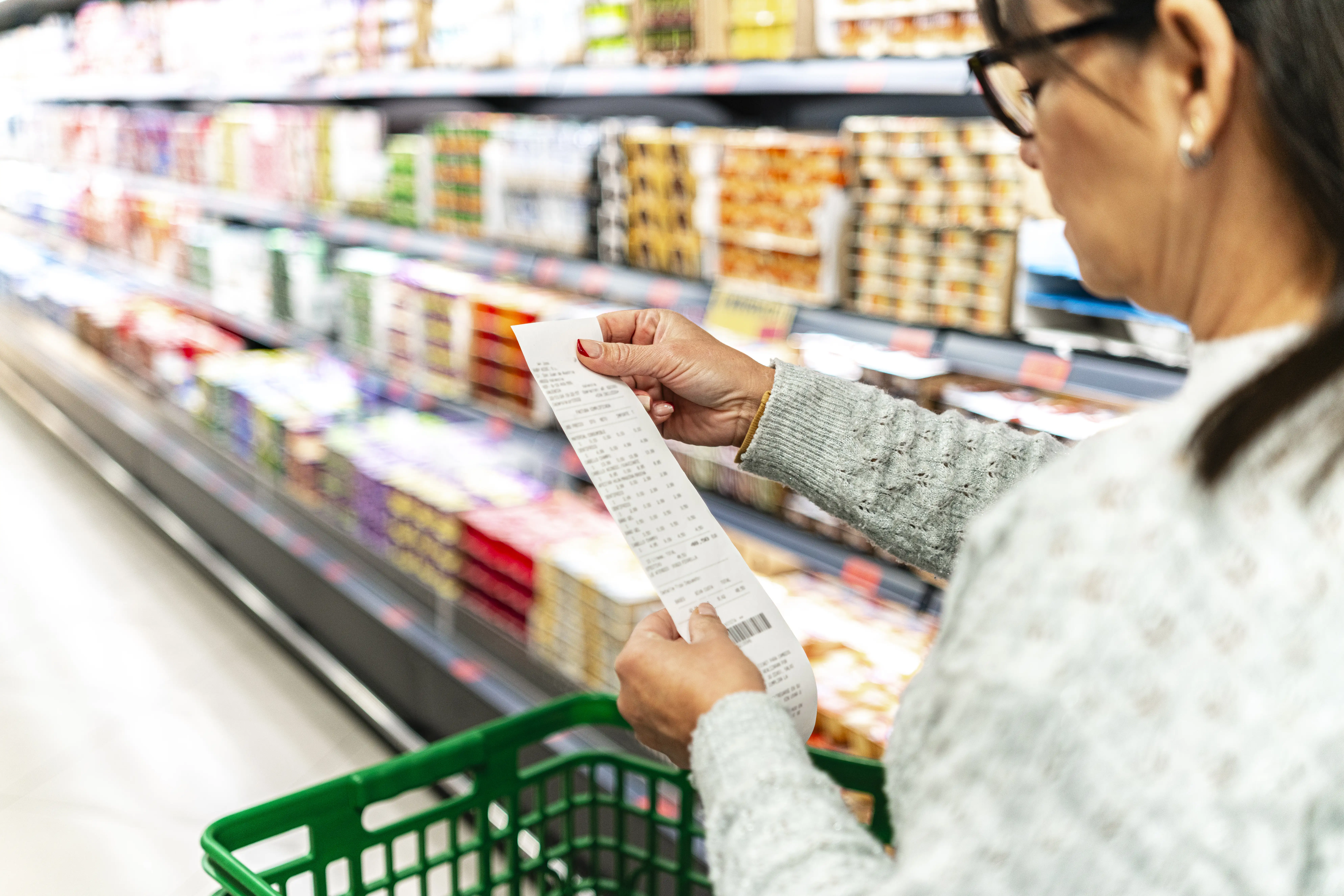 Woman checking a supermarket receipt