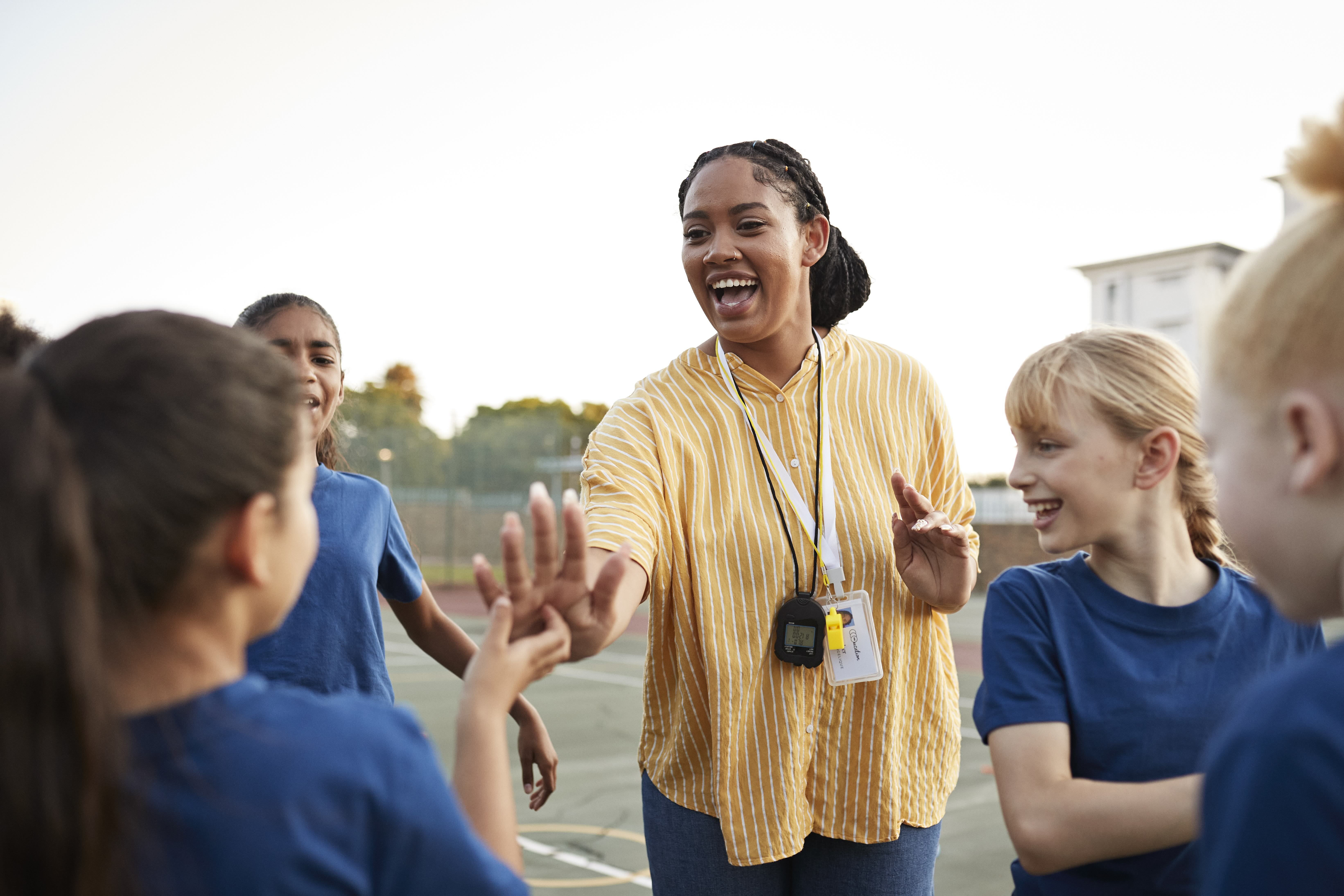 Teacher High Fiving Students