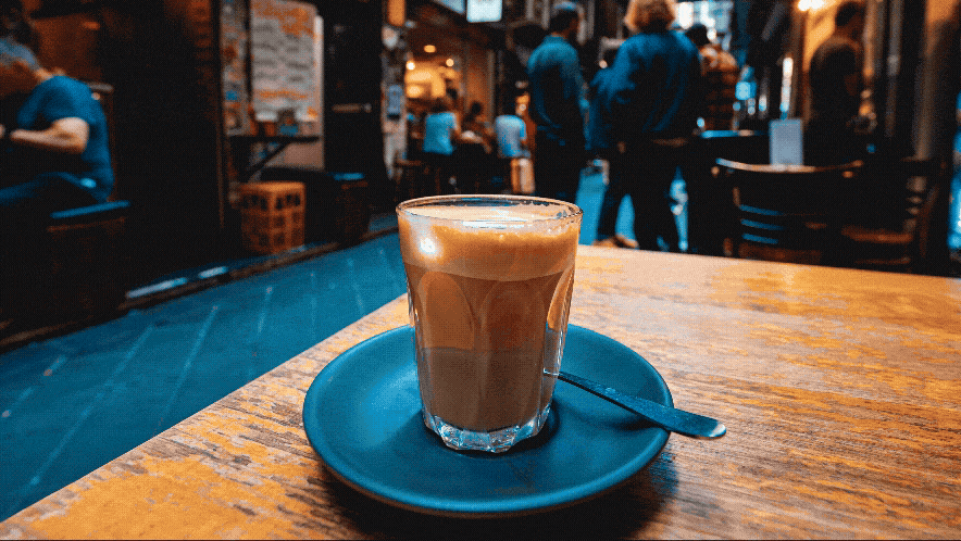 A coffee mug on a table in an outdoor cafe
