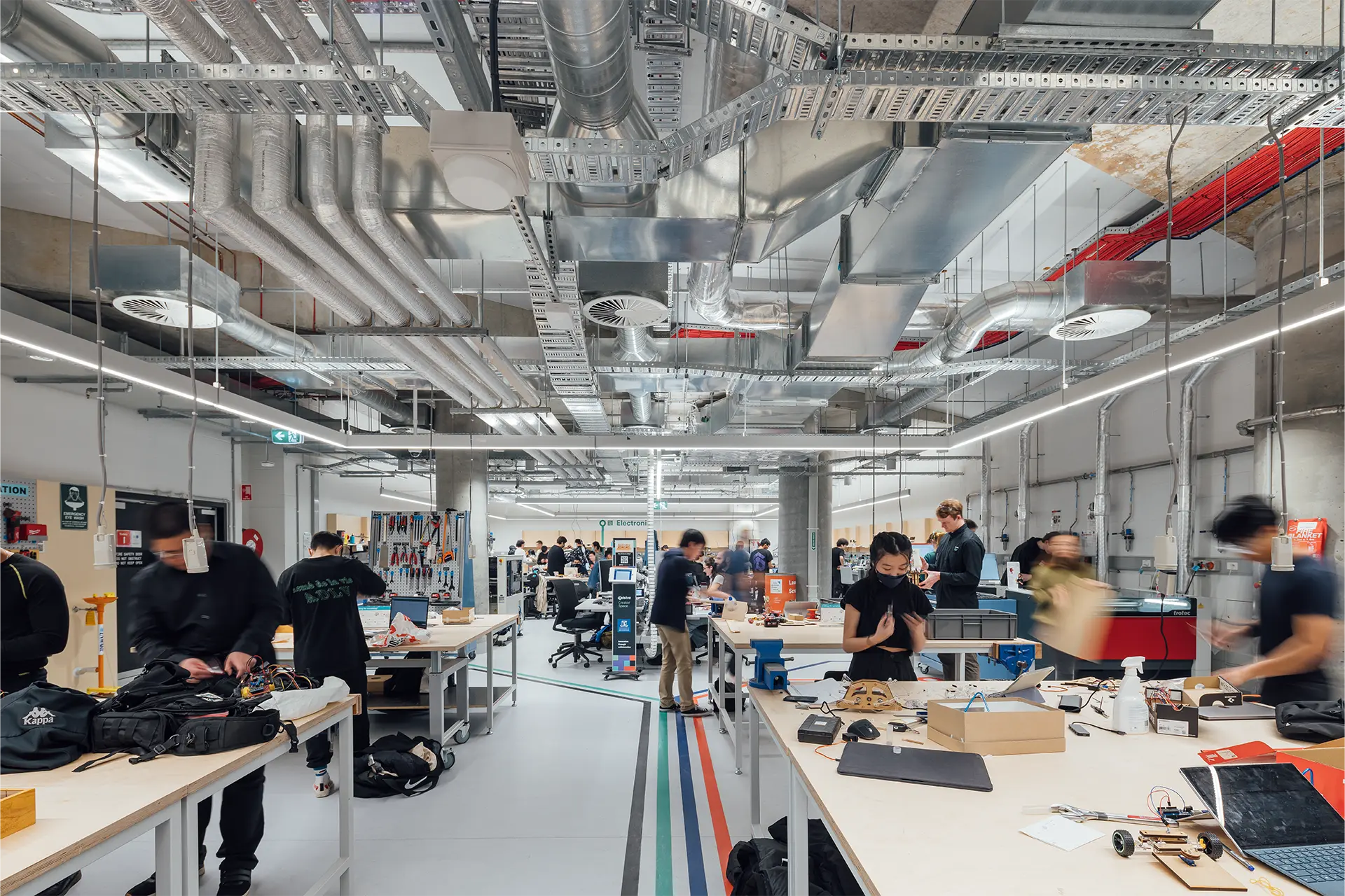 People working on electronics in a large laboratory