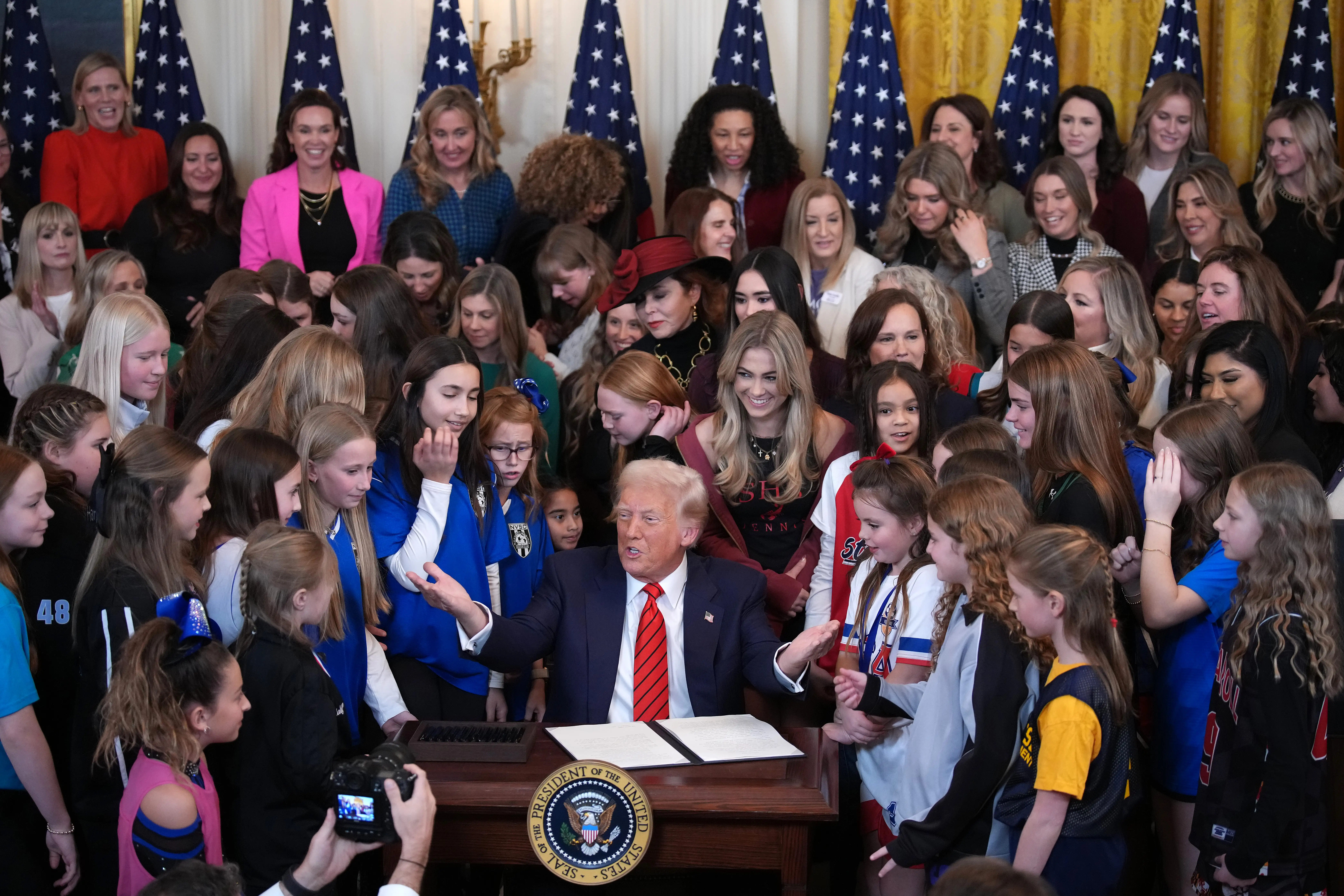 President Donald Trump joined by women athletes signs the “No Men in Women’s Sports” executive order 