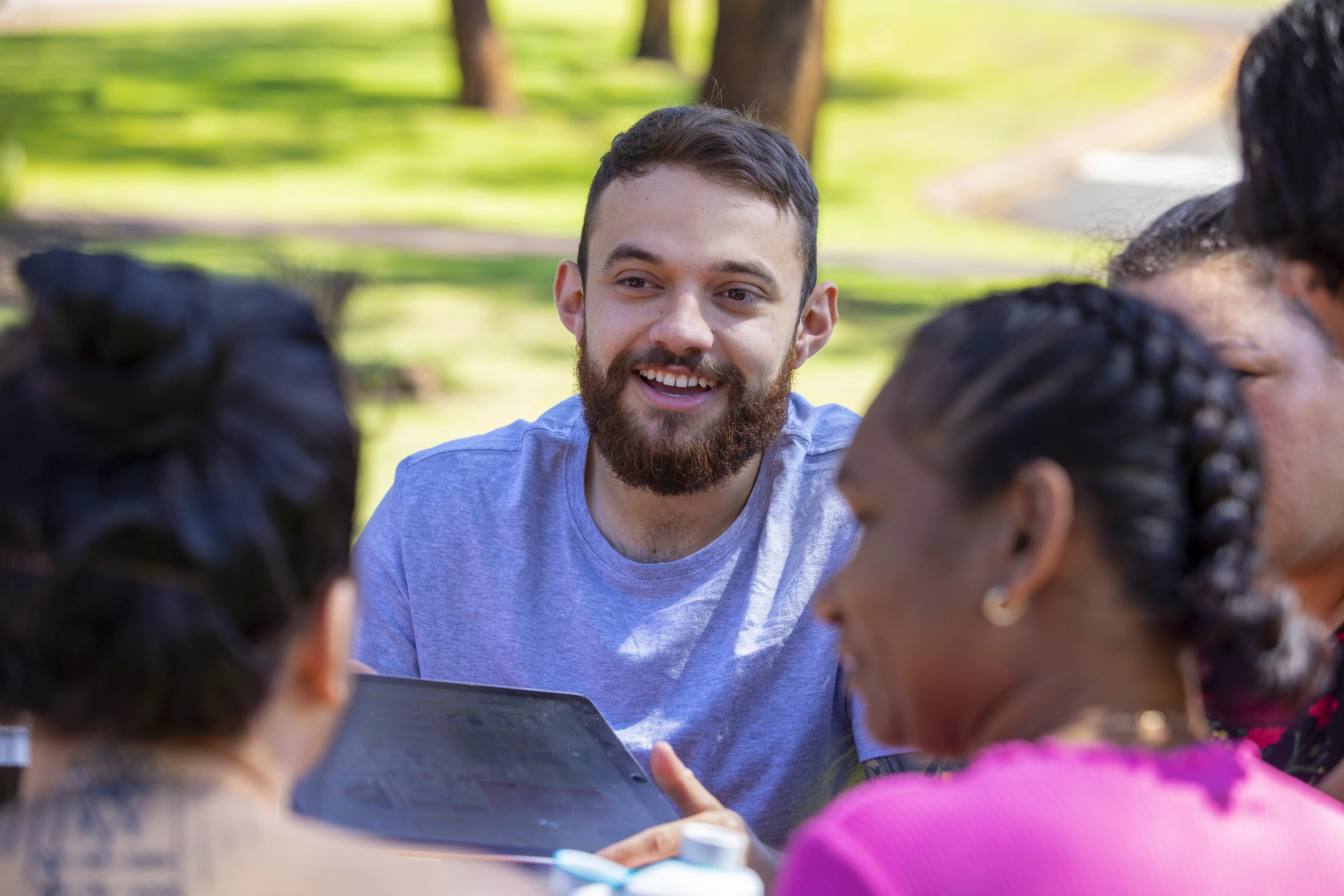 Close-up of young aboriginal students studying together outdoors.