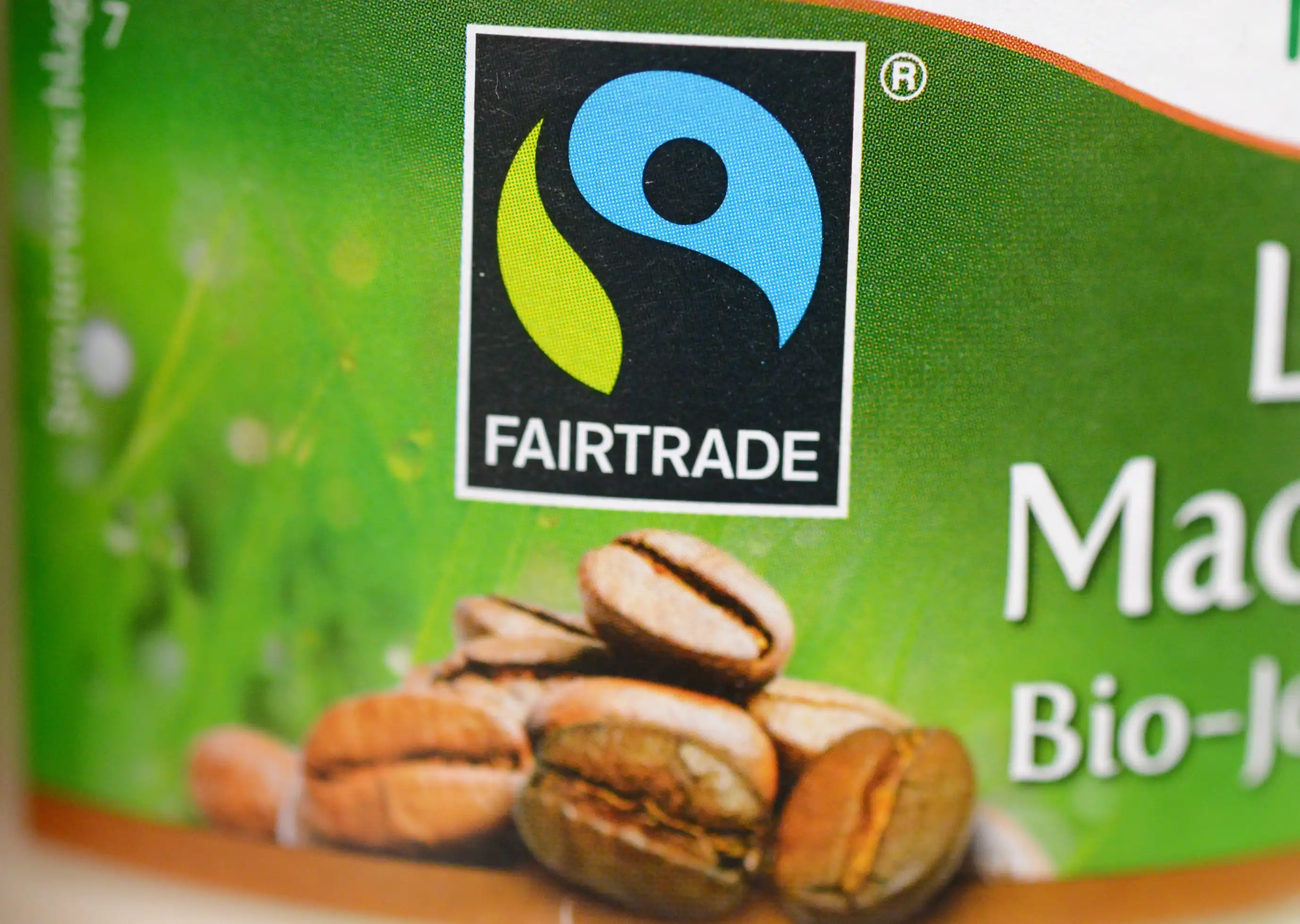A close up of a Fair Trade symbol on a coffee bean package