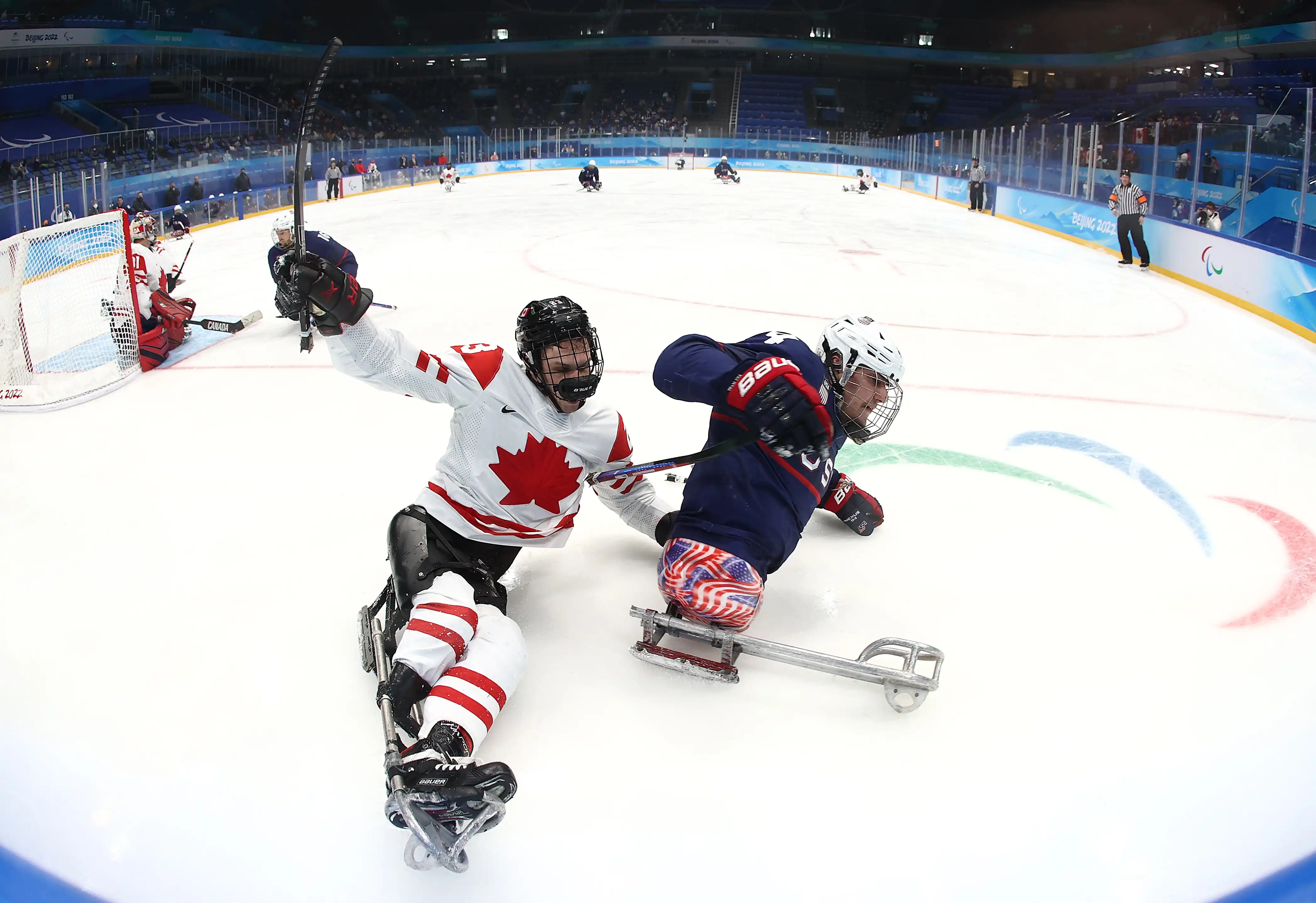 Two Paralympian hockey players from USA and Canada carve up the ice in their adapted skates