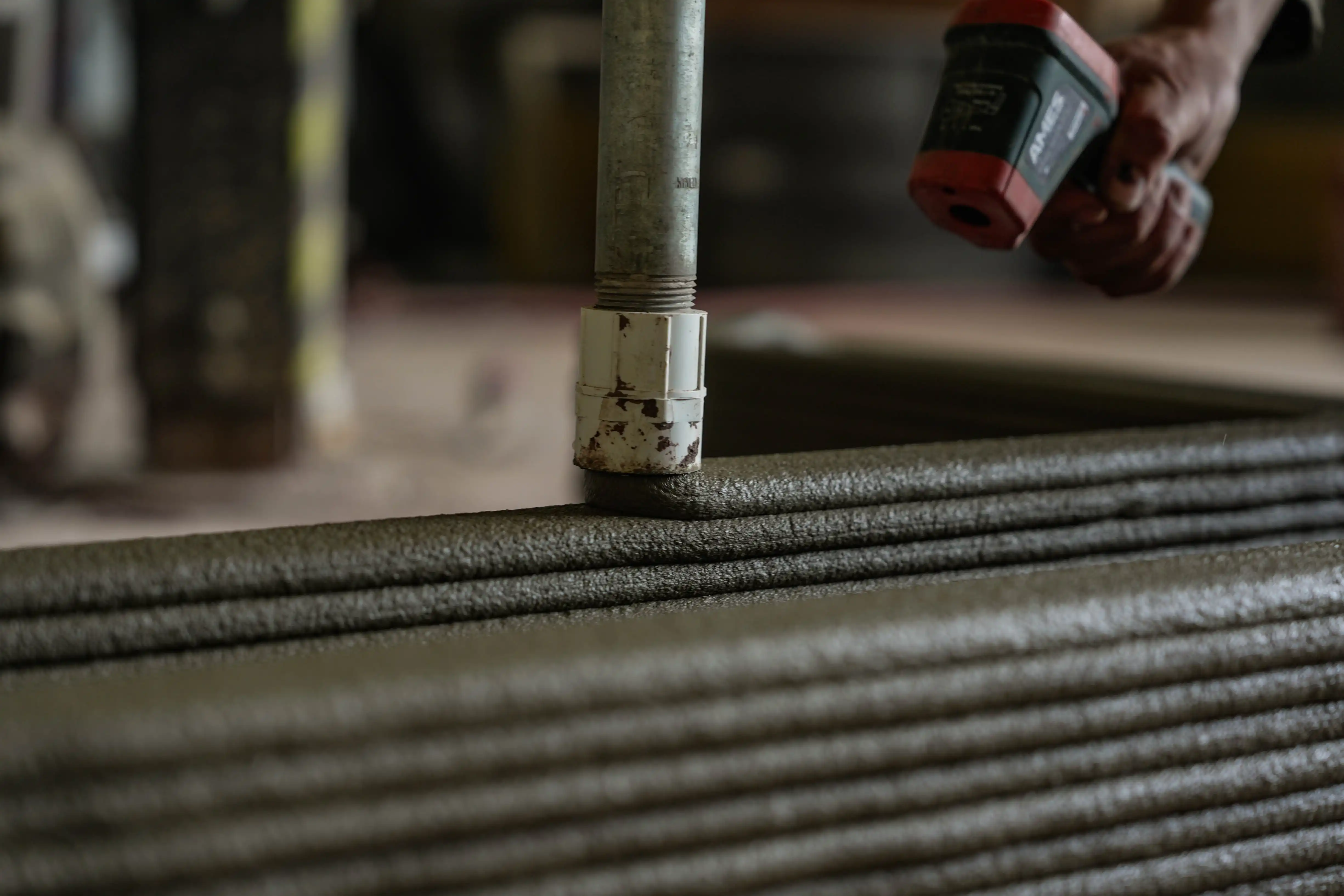 The walls of a building being constructed by a 3D printing machine