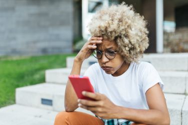 Woman exasperated at mobile message