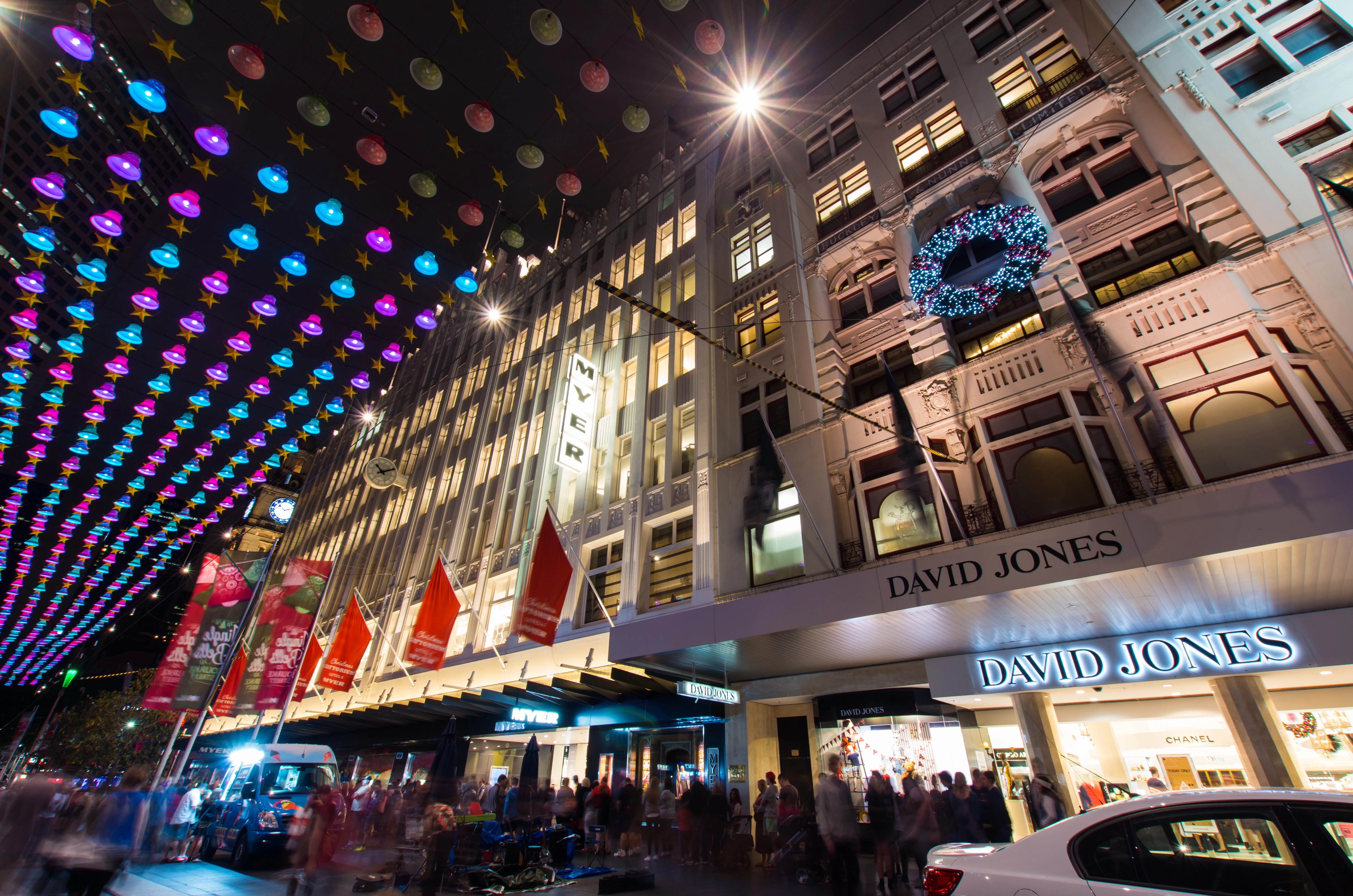 Bourke street in Melbourne at night during Christmas, with Myer and David Jones signs lighting up the night