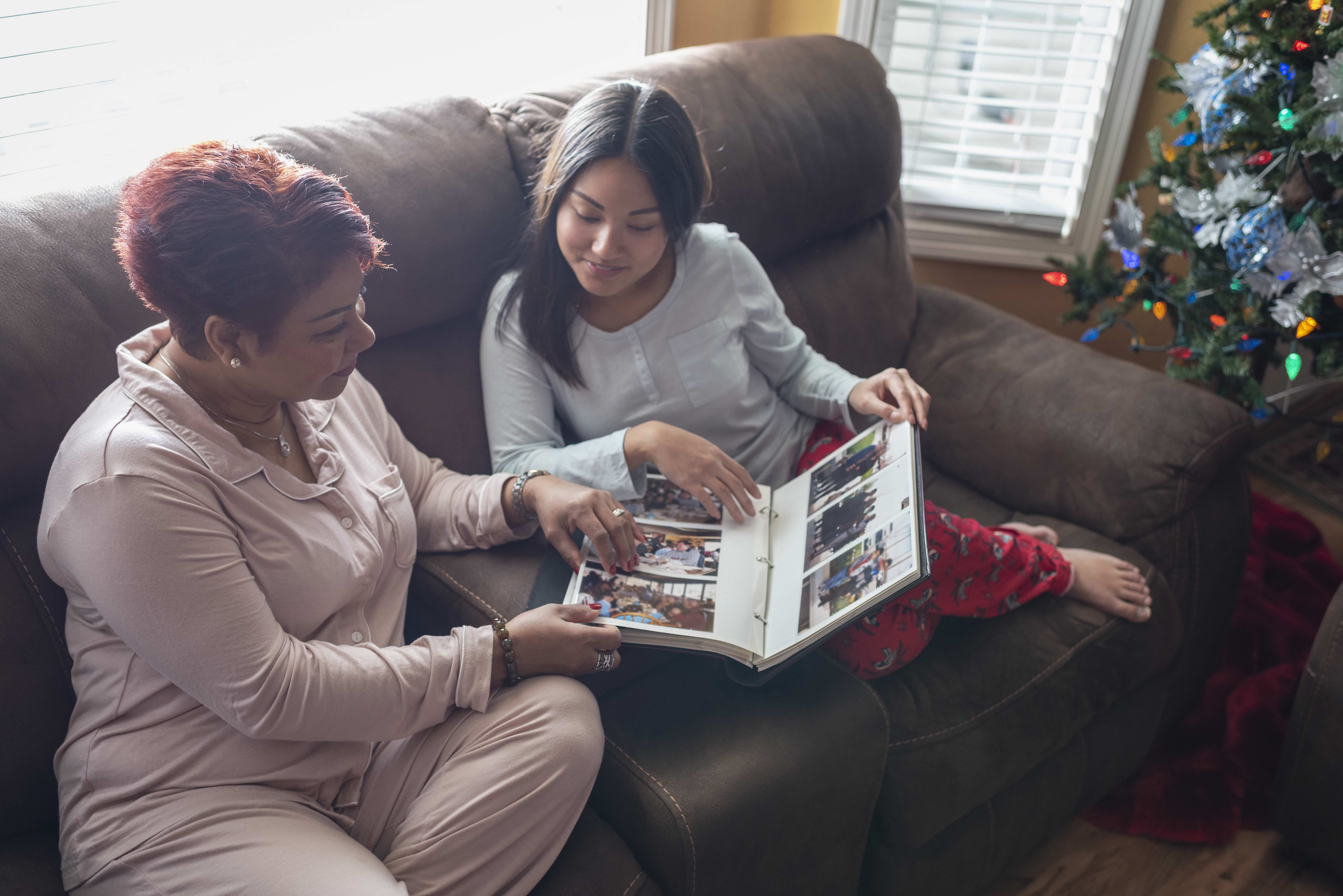 Mother and daughter looking at photo album