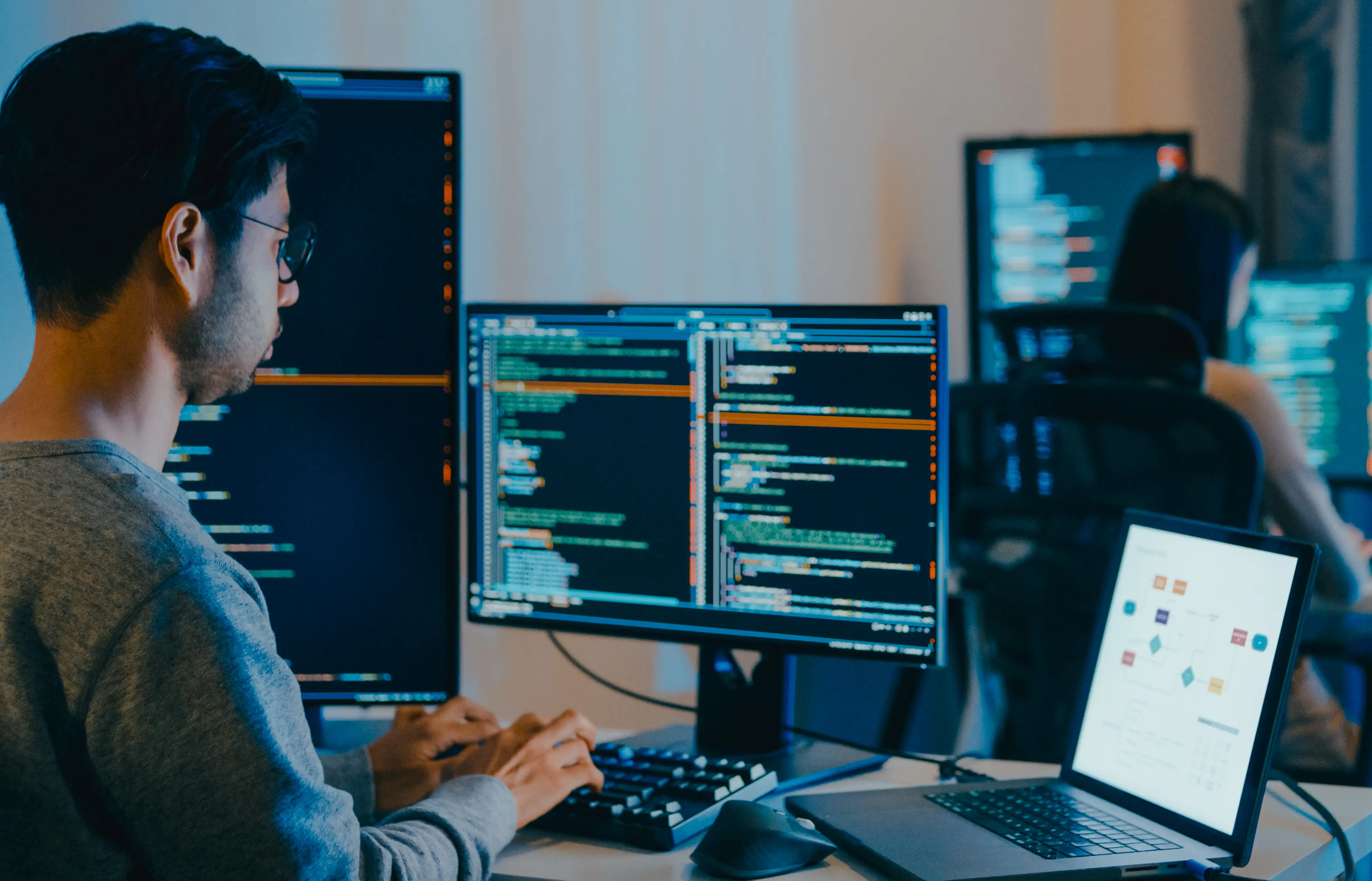 Two developers writing commands for AI