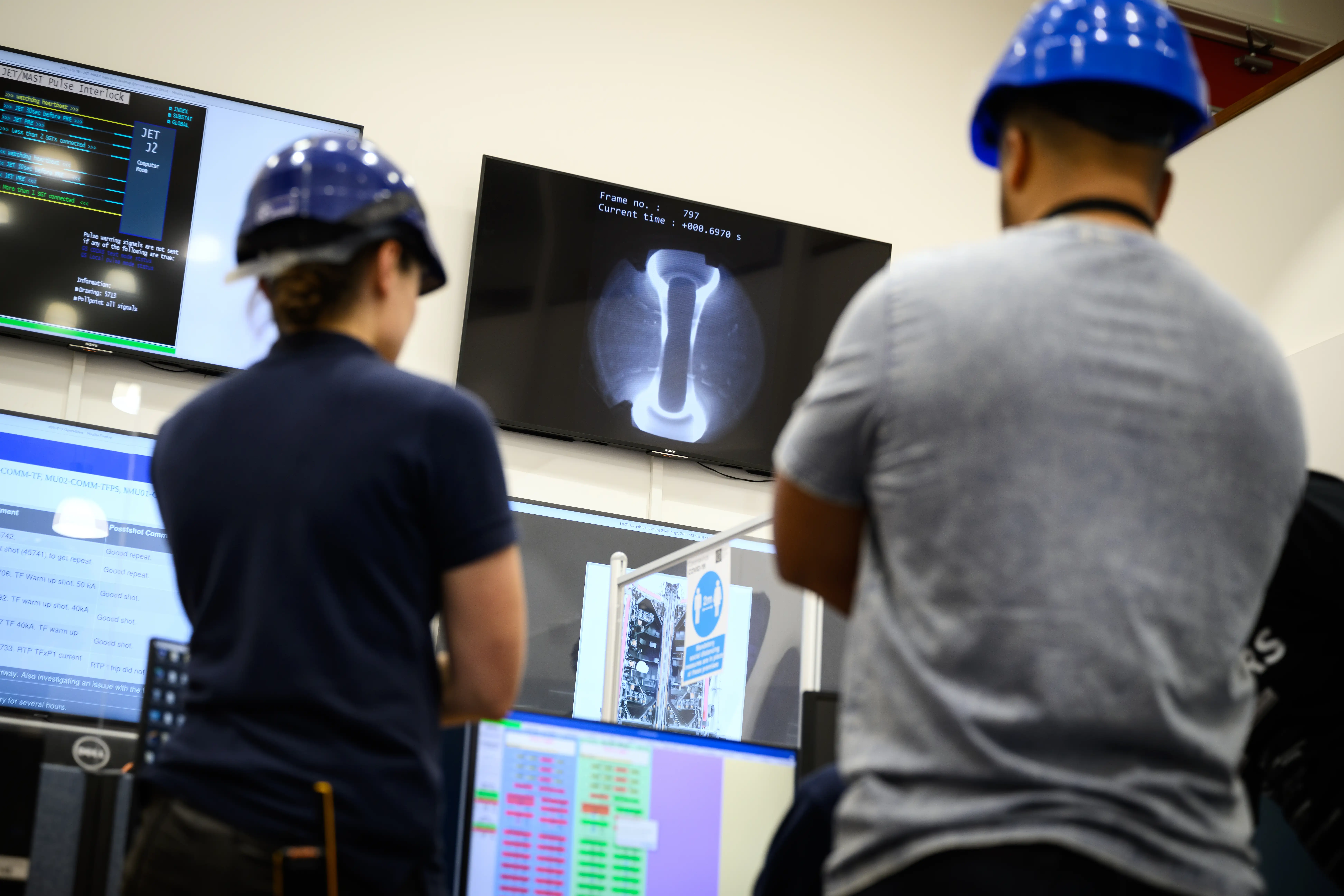 A research team look at test results in the Mega Amp Spherical Tokamak Upgrade (MAST-U) control room at the UK Atomic Energy Authority (UKAEA)