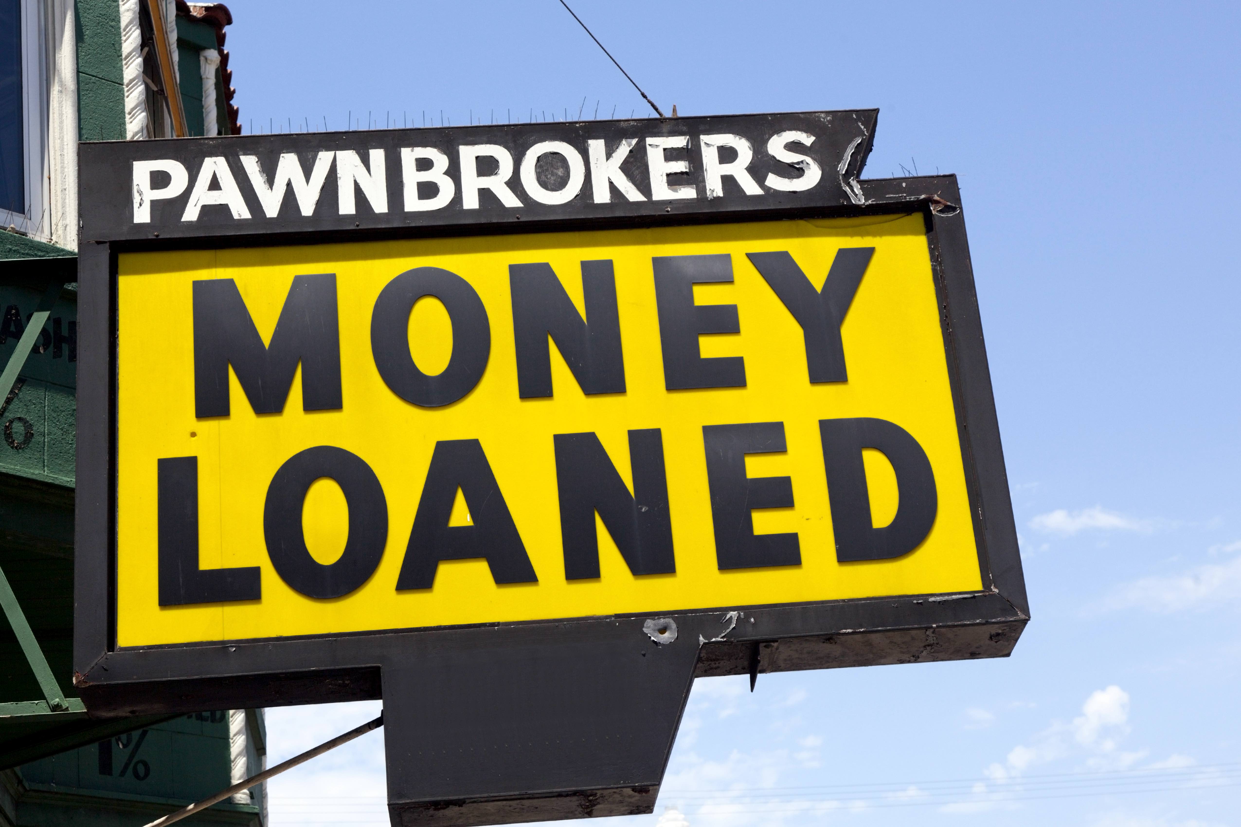 A pawn shops sign saying 'money loaned'