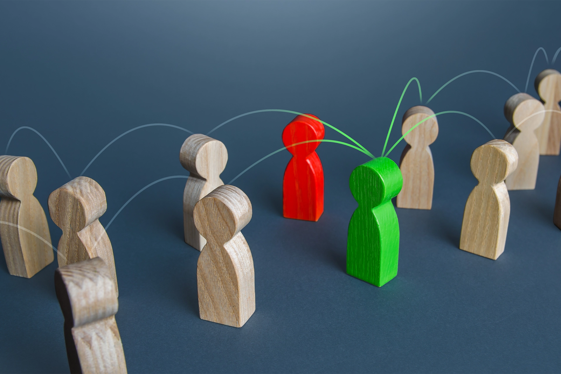 Wooden toy people linked by digital lines