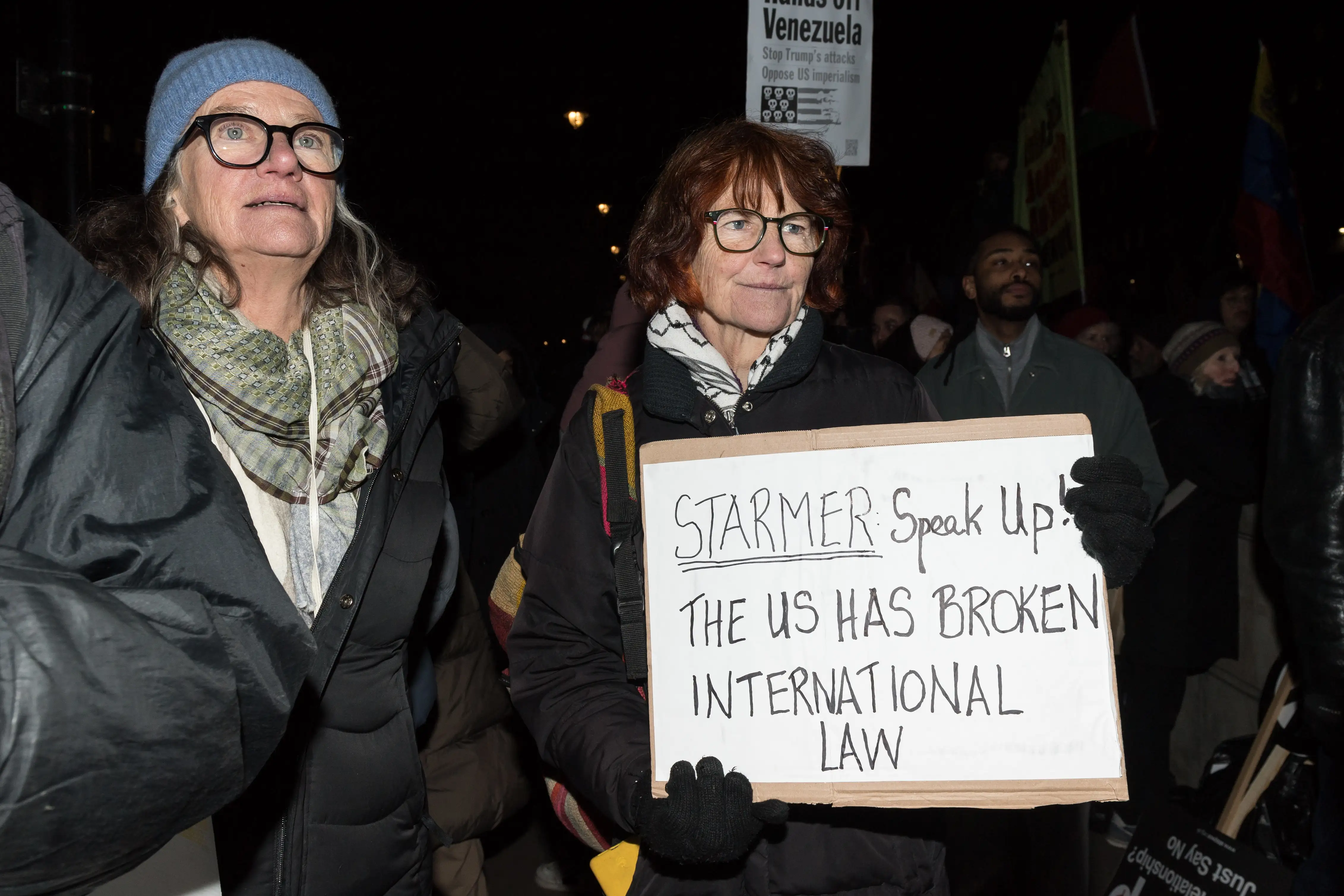 People gather outside Downing Street to protest against the US military attack on Venezuela.