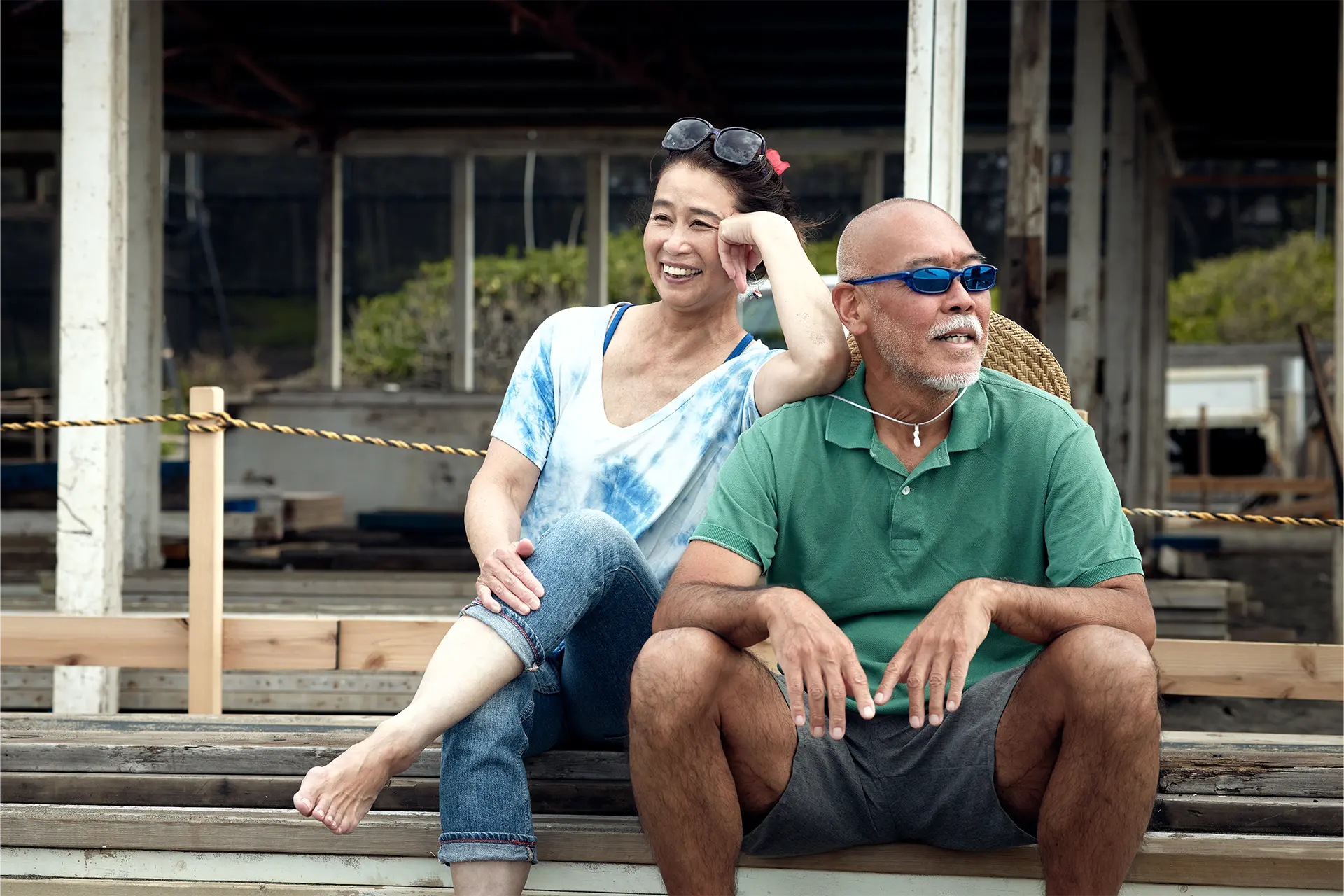 Elderly man and woman relaxing on a bench